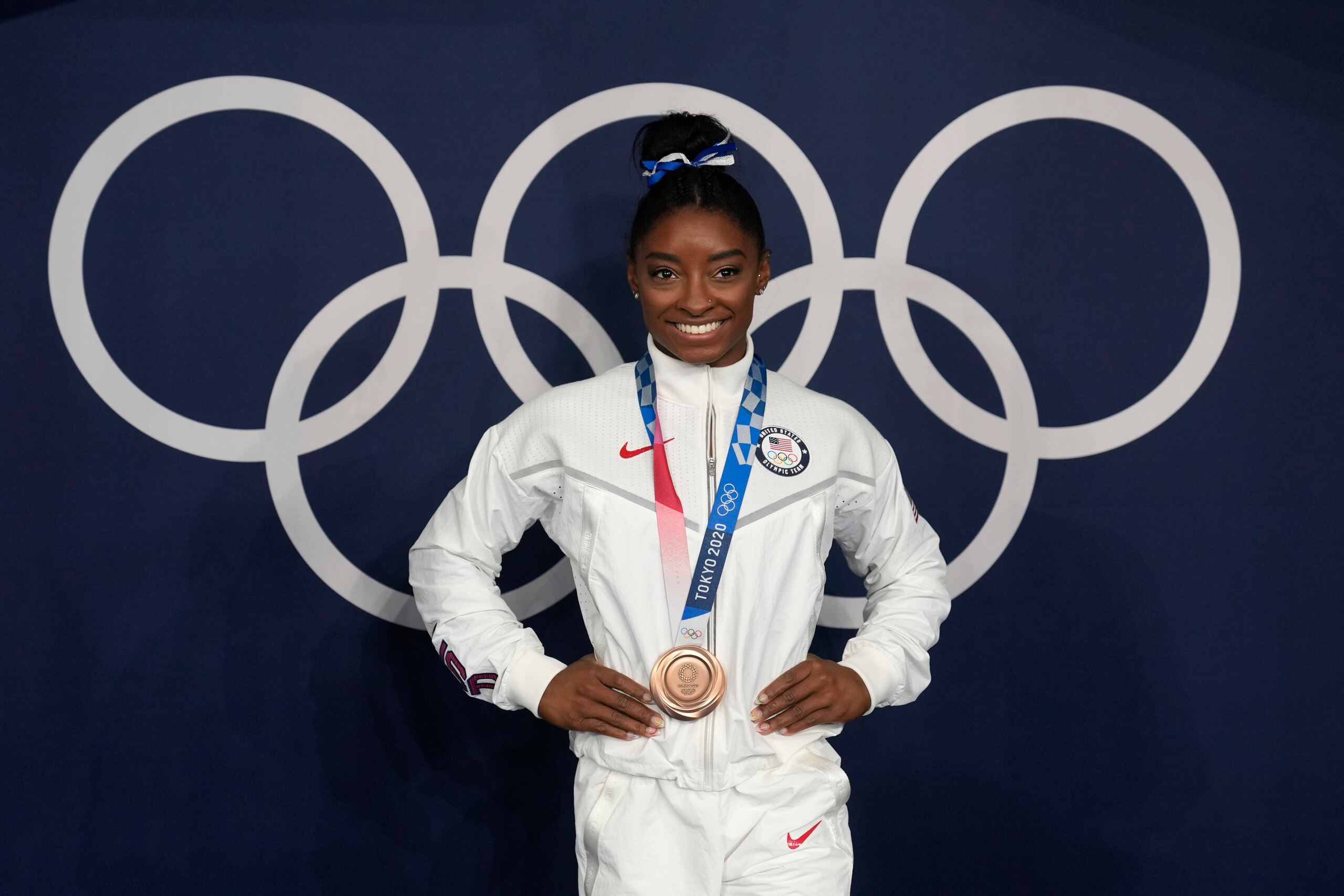 Simone Biles, of the United States, poses wearing her bronze medal from balance beam competition during artistic gymnastics at the 2020 Summer Olympics, Tuesday, Aug. 3, 2021, in Tokyo, Japan. (AP Photo/Natacha Pisarenko)