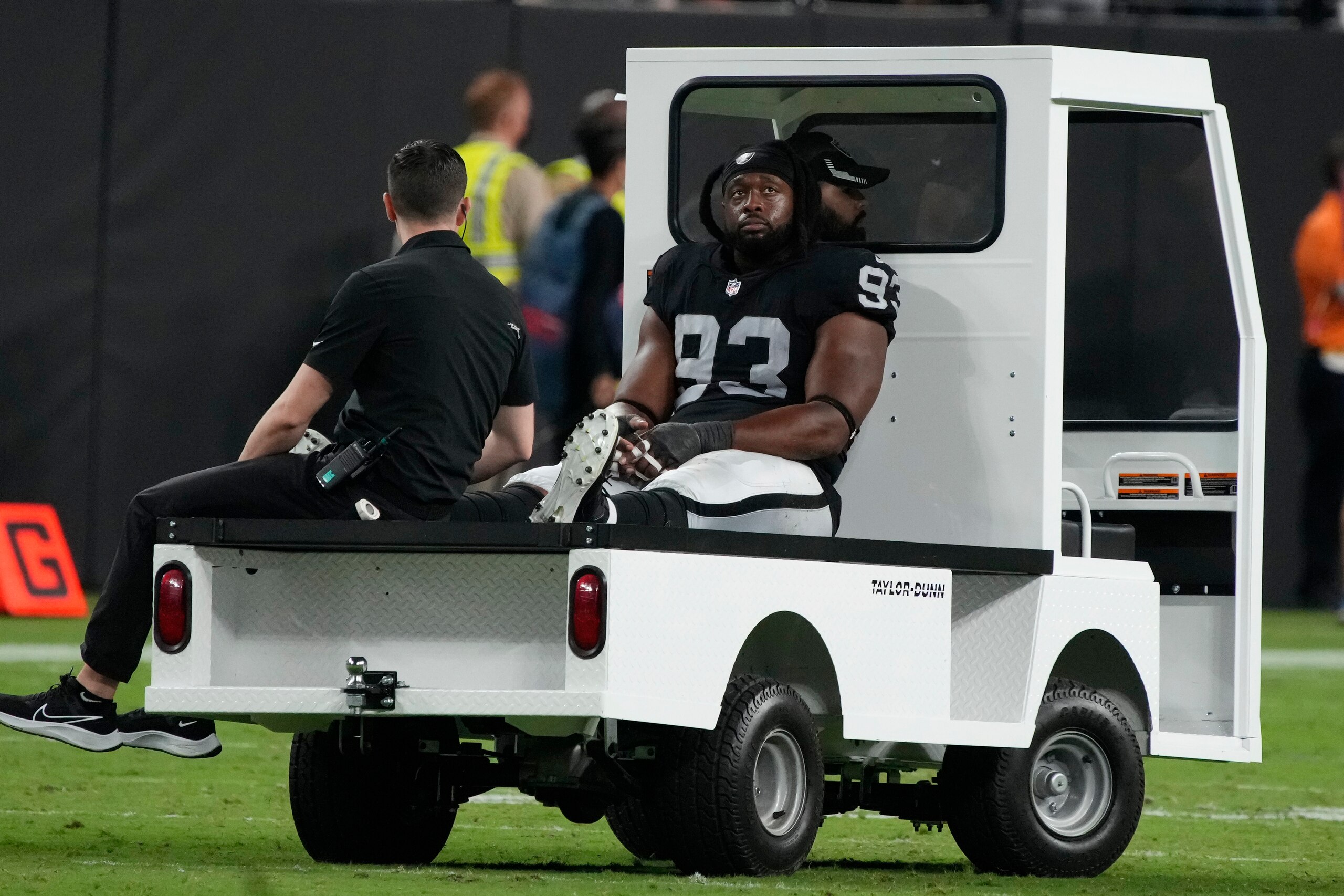 Las Vegas Raiders defensive tackle Gerald McCoy (93) is taken off the field during the second half of an NFL football game against the Baltimore Ravens, Monday, Sept. 13, 2021, in Las Vegas. (AP Photo/Rick Scuteri)