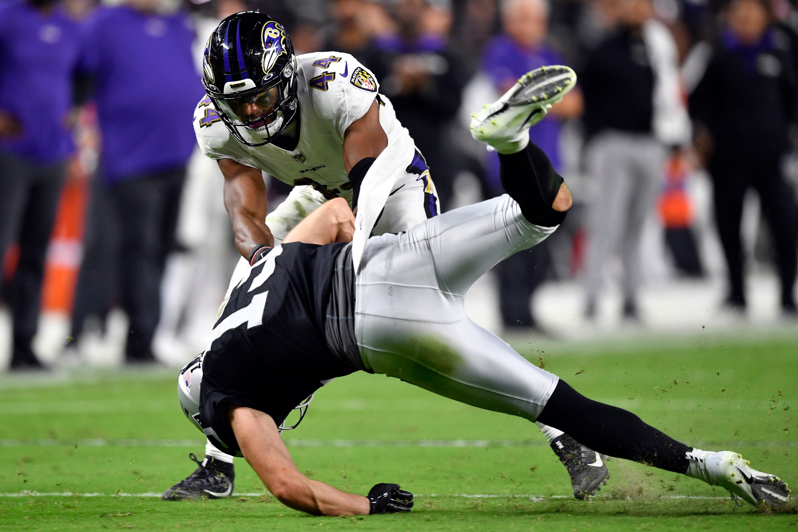 LAS VEGAS, NEVADA - SEPTEMBER 13: Marlon Humphrey #44 of the Baltimore Ravens tackles Hunter Renfrow #13 of the Las Vegas Raiders in the third quarter at Allegiant Stadium on September 13, 2021 in Las Vegas, Nevada. (Photo by Chris Unger/Getty Images)