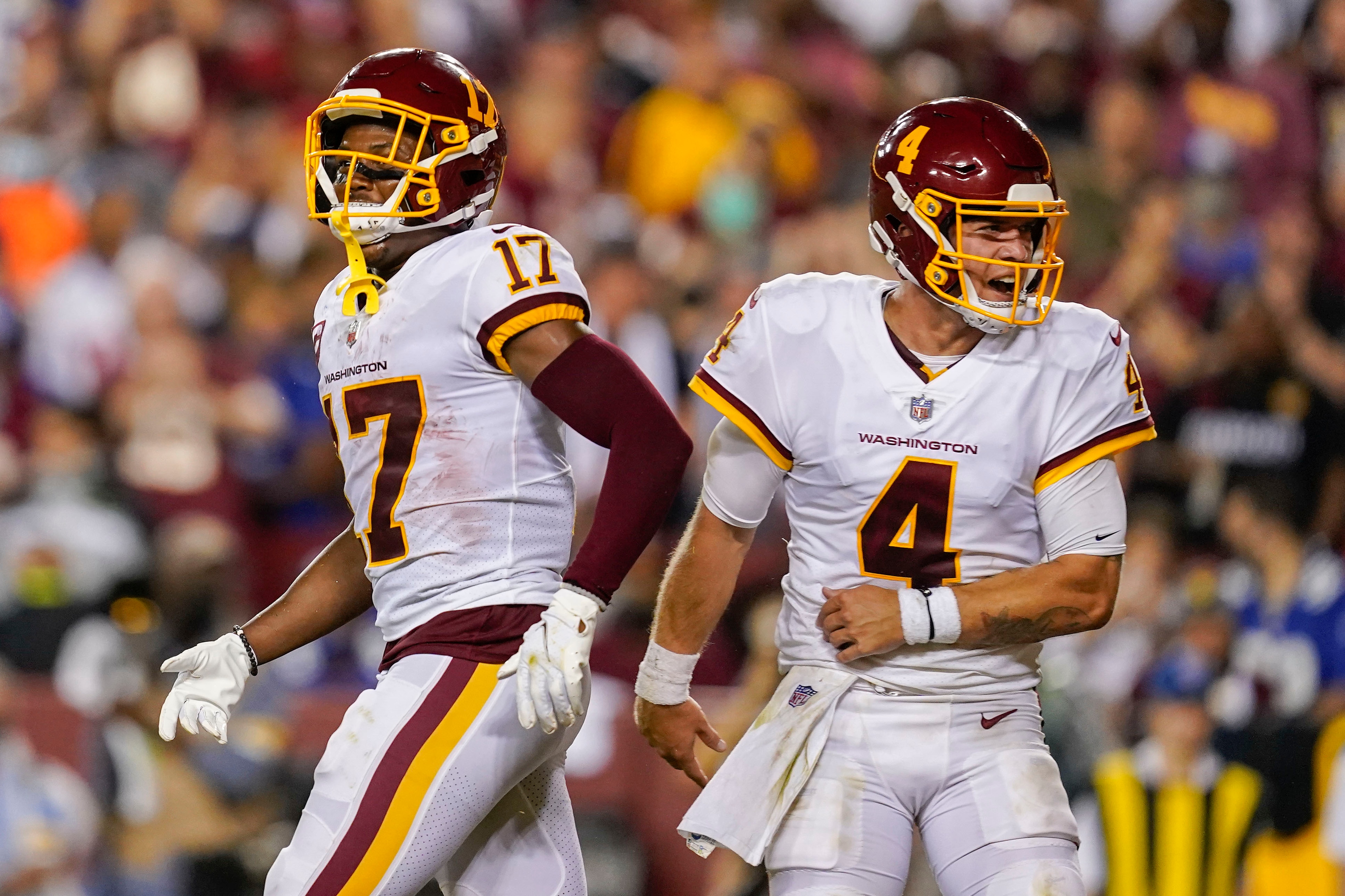 Washington Football Team wide receiver Terry McLaurin (17) and quarterback Taylor Heinicke (4) celebrating their touchdown against the New York Giants during the first half of an NFL football game, Thursday, Sept. 16, 2021, in Landover, Md. (AP Photo/Alex Brandon)