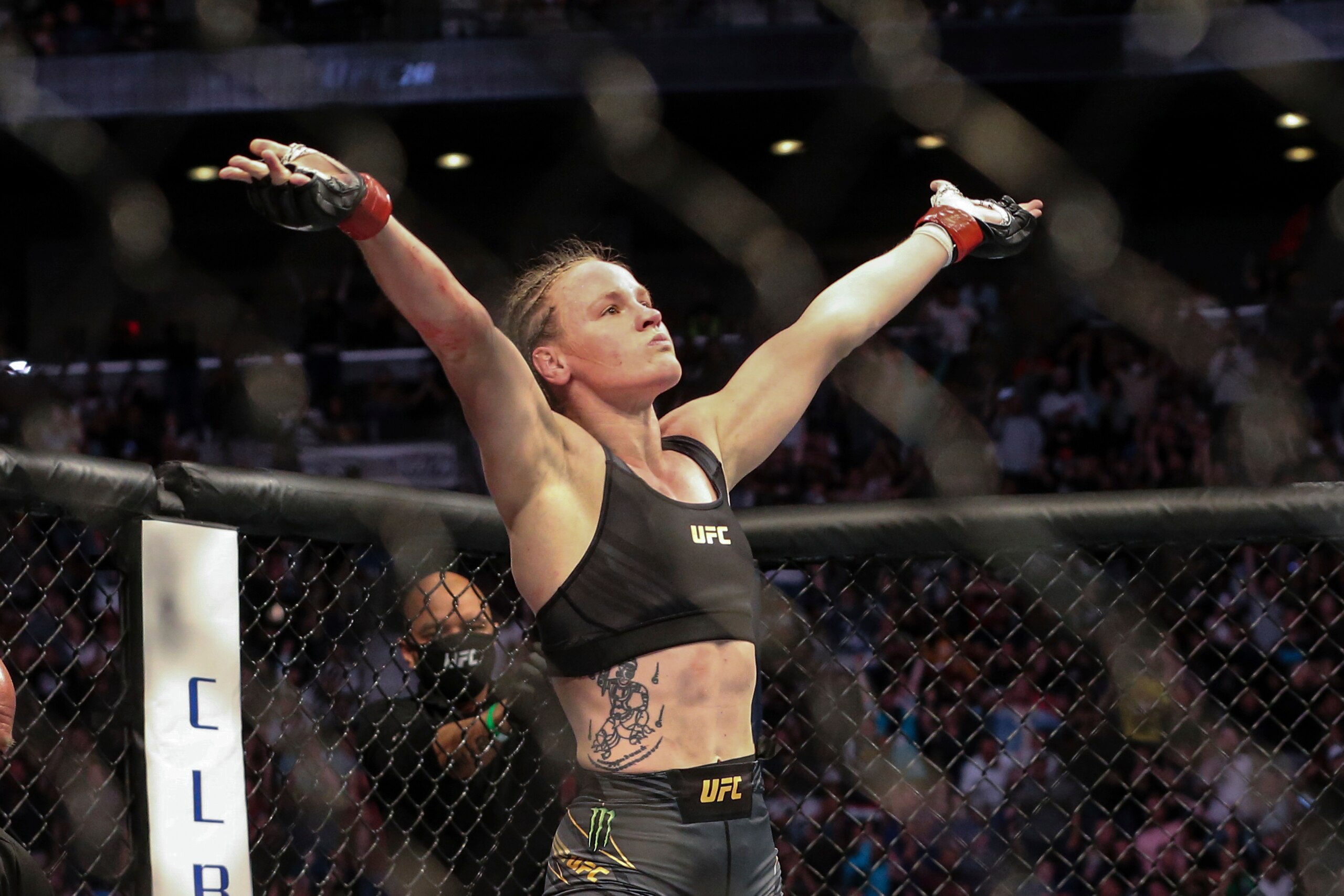 Valentina Shevchenko celebrates her win at the end of her UFC 261 mixed martial arts bout against Jessica Andrade, Saturday, April 24, 2021, in Jacksonville, Fla. It is the first UFC event since the onset of the COVID-19 pandemic to feature a full crowd in attendance. (AP Photo/Gary McCullough)