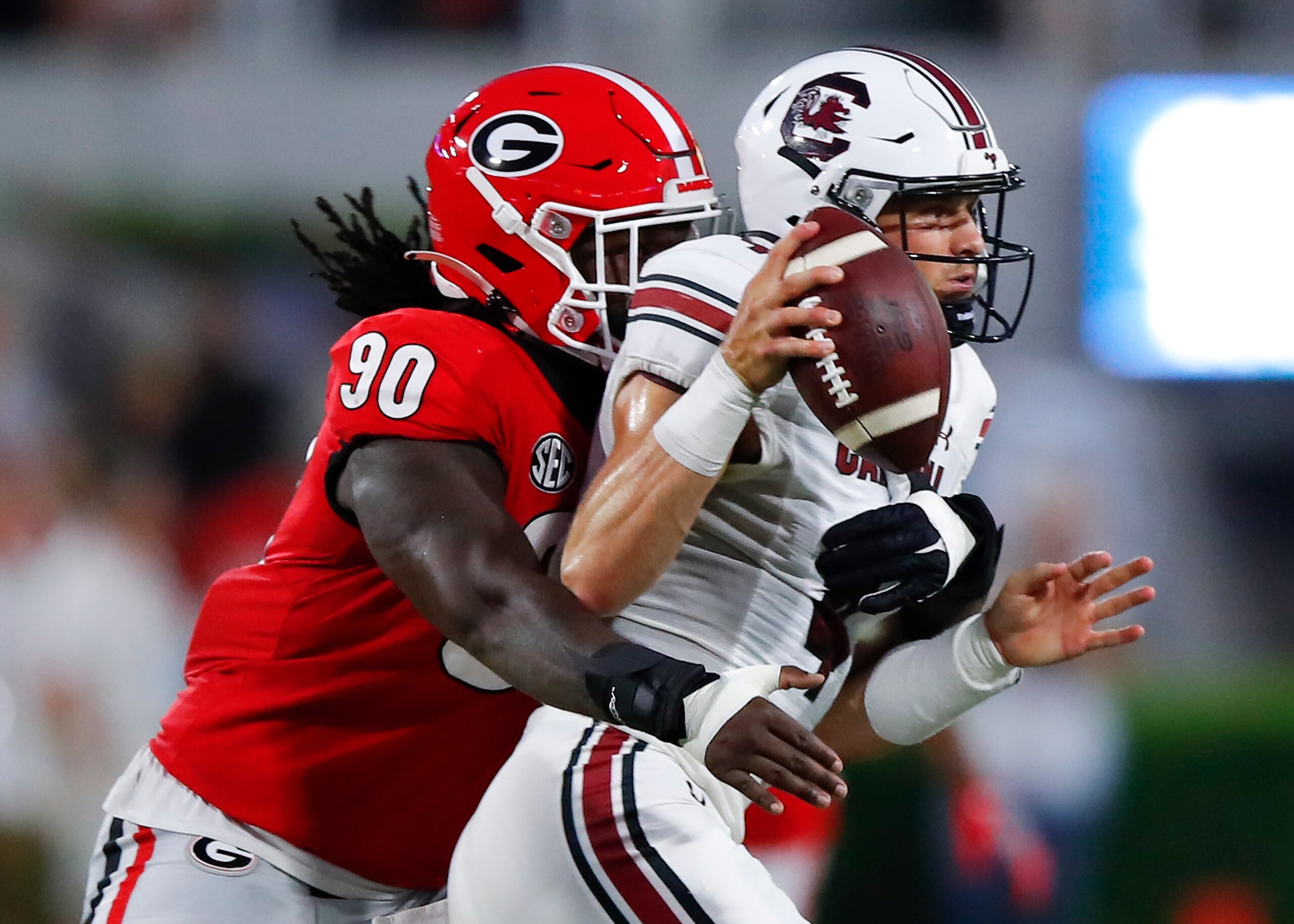 ATHENS, GA - SEPTEMBER 18: Luke Doty #4 of the South Carolina Gamecocks is pressured by Tramel Walthour #90 of the Georgia Bulldogs during the first half at Sanford Stadium on September 18, 2021 in Athens, Georgia. (Photo by Todd Kirkland/Getty Images)