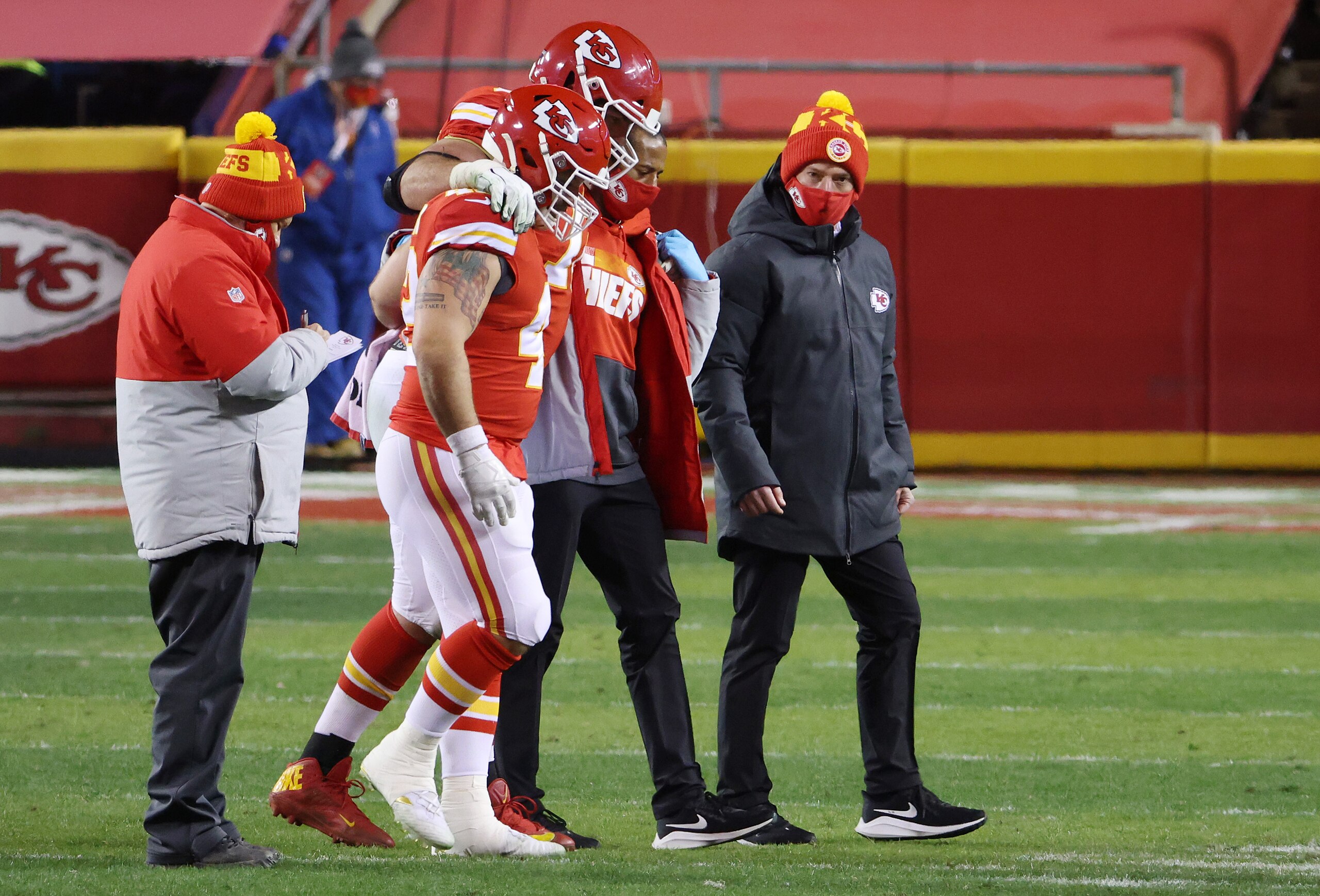 KANSAS CITY, MISSOURI - JANUARY 24: Eric Fisher #72 of the Kansas City Chiefs is helped off the field in the fourth quarter against the Buffalo Bills during the AFC Championship game at Arrowhead Stadium on January 24, 2021 in Kansas City, Missouri. (Photo by Jamie Squire/Getty Images)