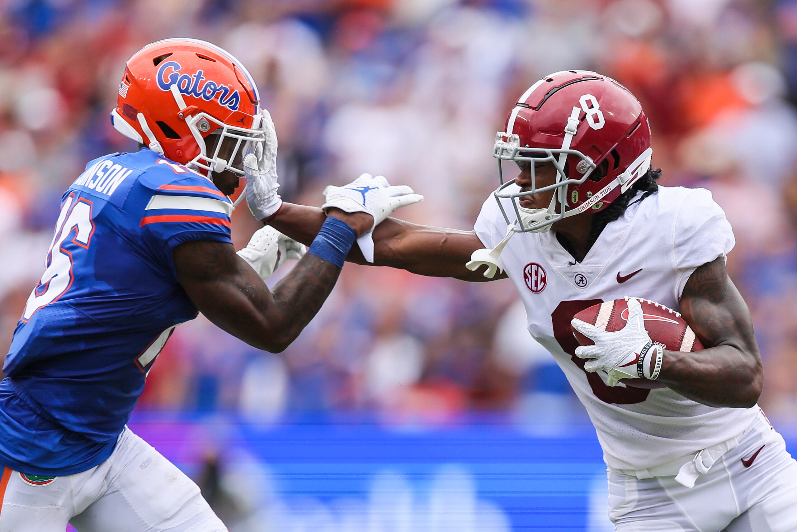 GAINESVILLE, FLORIDA - SEPTEMBER 18: John Metchie III #8 of the Alabama Crimson Tide runs for yardage against Tre'Vez Johnson #16 of the Florida Gators during the first quarter of a game at Ben Hill Griffin Stadium on September 18, 2021 in Gainesville, Florida. (Photo by James Gilbert/Getty Images)
