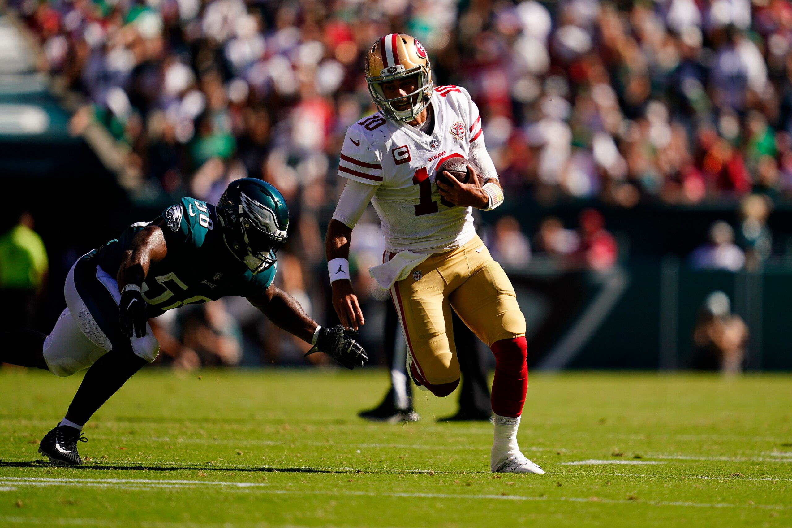 San Francisco 49ers quarterback Jimmy Garoppolo (10) runs with the ball past Philadelphia Eagles linebacker Genard Avery (58) during the second half of an NFL football game Sunday, Sept. 19, 2021, in Philadelphia. (AP Photo/Matt Slocum)