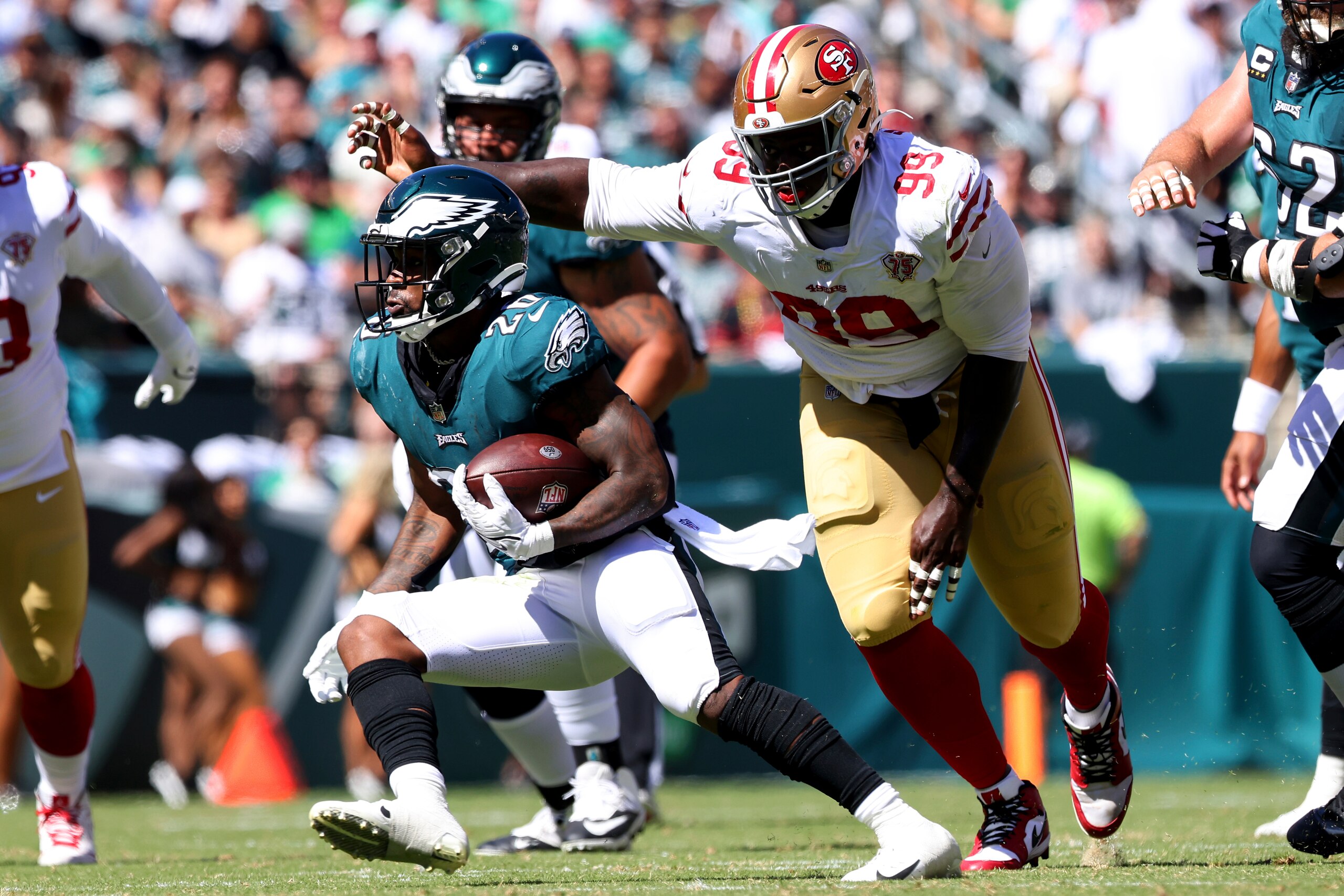 Philadelphia Eagles' Miles Sanders (26) runs as San Francisco 49ers' Javon Kinlaw (99) pursues during the first half of an NFL football game, Thursday, Aug. 19, 2021, in Philadelphia. (AP Photo/Rich Schultz)