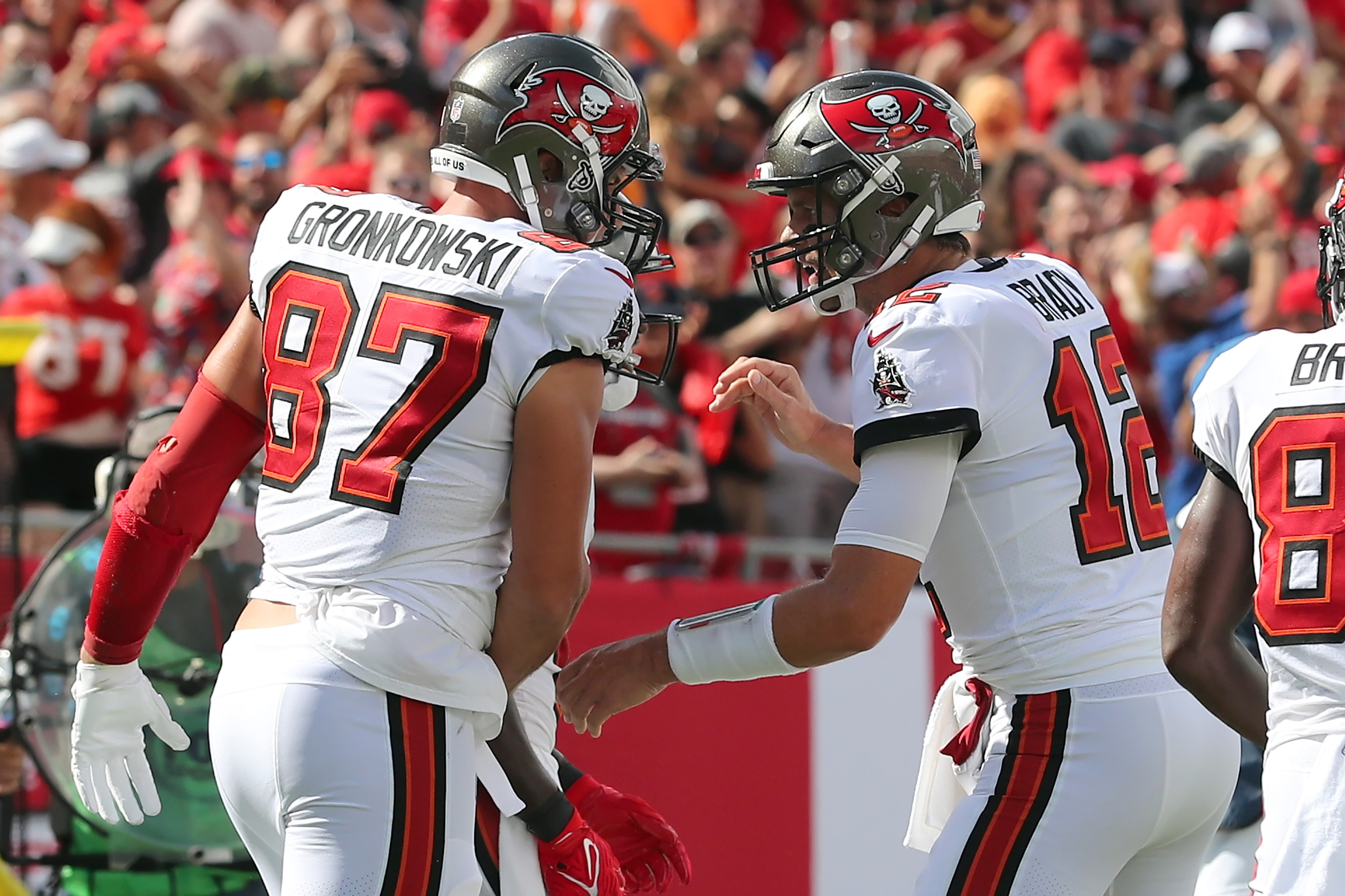 TAMPA, FL - SEPTEMBER 19: Tampa Bay Buccaneers Tight End Rob Gronkowski (87) scores a touchdown and is congratulated by Quarterback Tom Brady (12) during the regular season game between the Atlanta Falcons and the Tampa Bay Buccaneers on September 19, 2021 at Raymond James Stadium in Tampa, Florida. (Photo by Cliff Welch/Icon Sportswire via Getty Images)