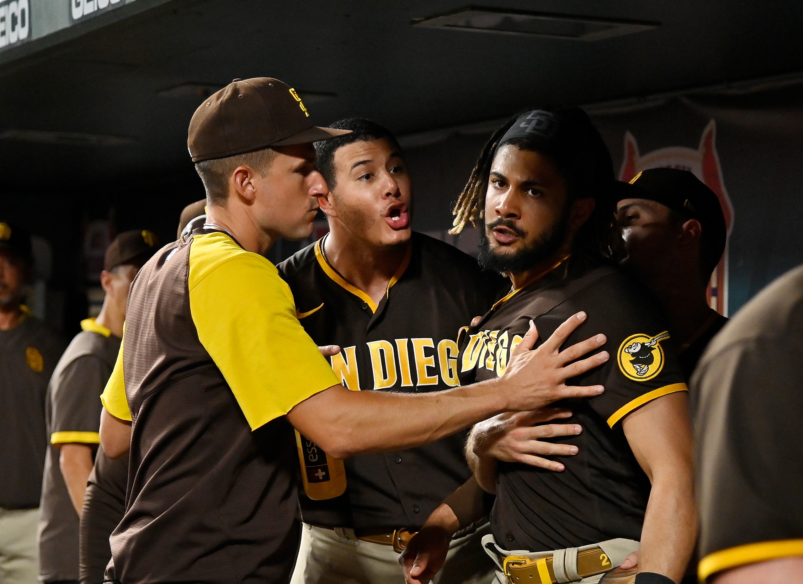 ST LOUIS, MO - SEPTEMBER 18:  Manny Machado #13 and Fernando Tatis Jr. #23 of the San Diego Padres exchange words in the dugout during the fifth inning against the St. Louis Cardinals at Busch Stadium on September 18, 2021 in St Louis, Missouri. (Photo by Jeff Curry/Getty Images)
