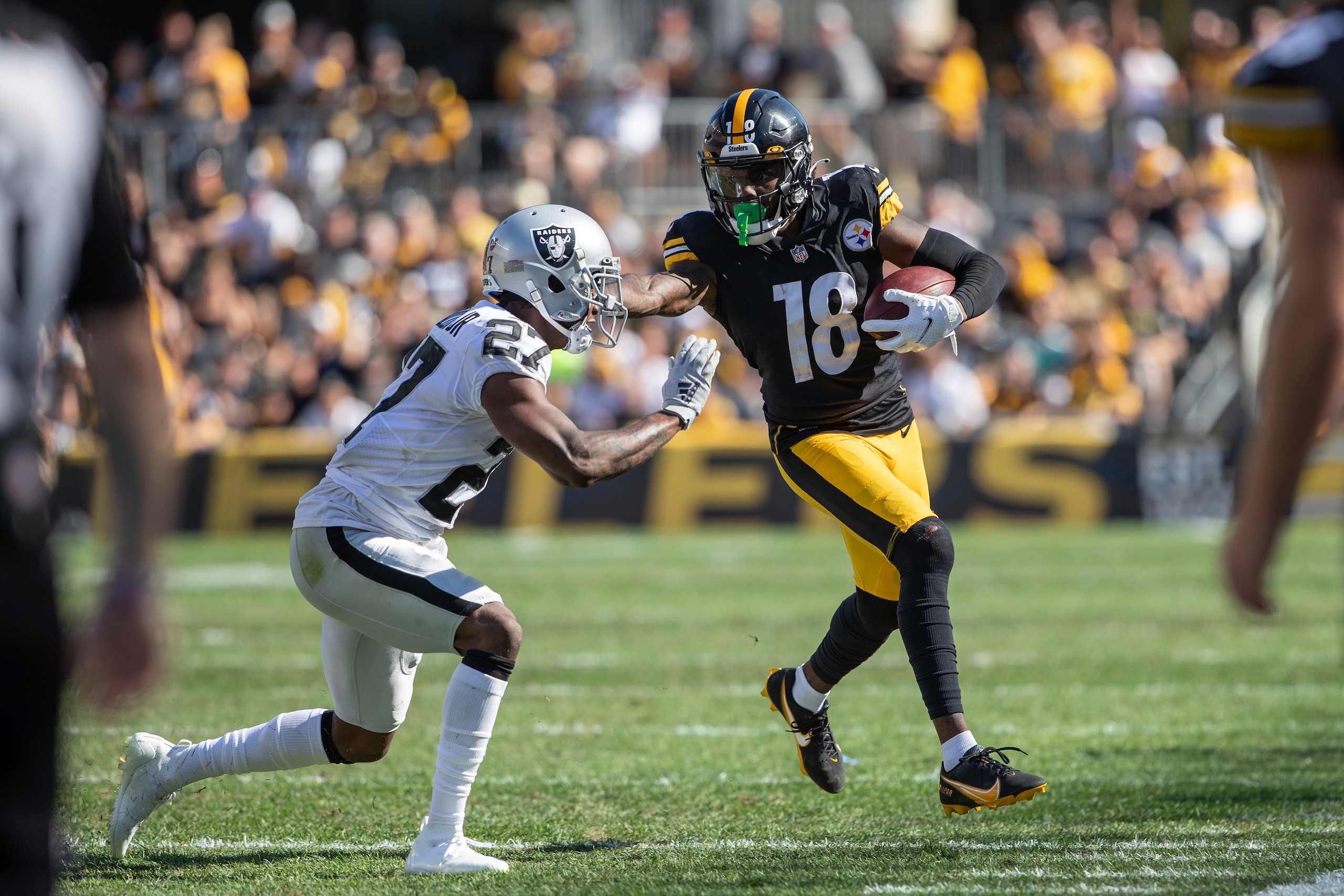 Pittsburgh Steelers wide receiver Diontae Johnson (18) runs after the catch in front of Las Vegas Raiders cornerback Trayvon Mullen (27) during an NFL football game, Sunday, Sept. 19, 2021 in Pittsburgh. (AP Photo/Matt Durisko)