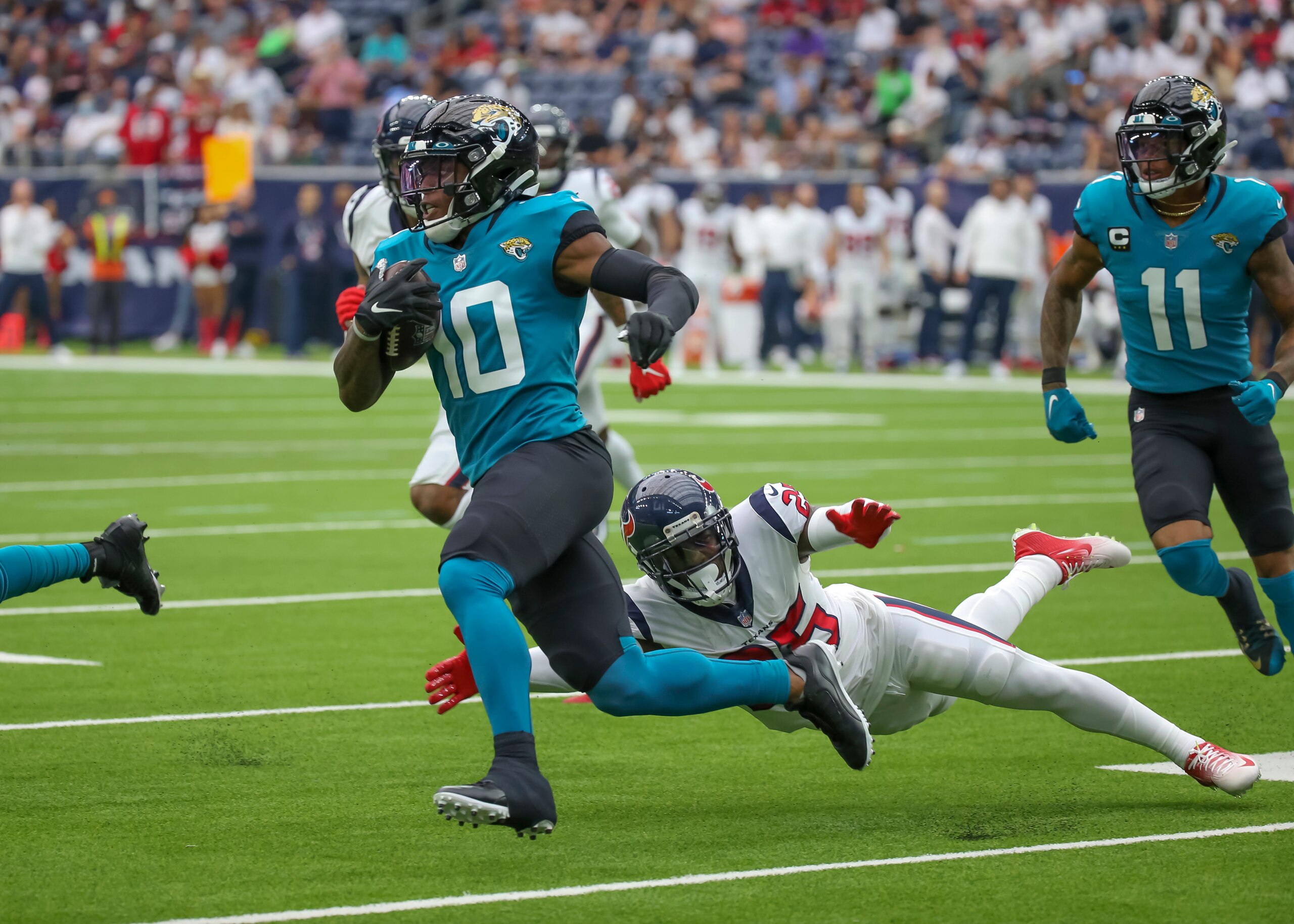 HOUSTON, TX - SEPTEMBER 12:  Jacksonville Jaguars wide receiver Laviska Shenault Jr. (10) evades a tackle by Houston Texans defensive back Desmond King (25) during the football game between the Jacksonville Jaguars and Houston Texans on September 12, 2021 at NRG Stadium in Houston, Texas.  (Photo by Leslie Plaza Johnson/Icon Sportswire via Getty Images)