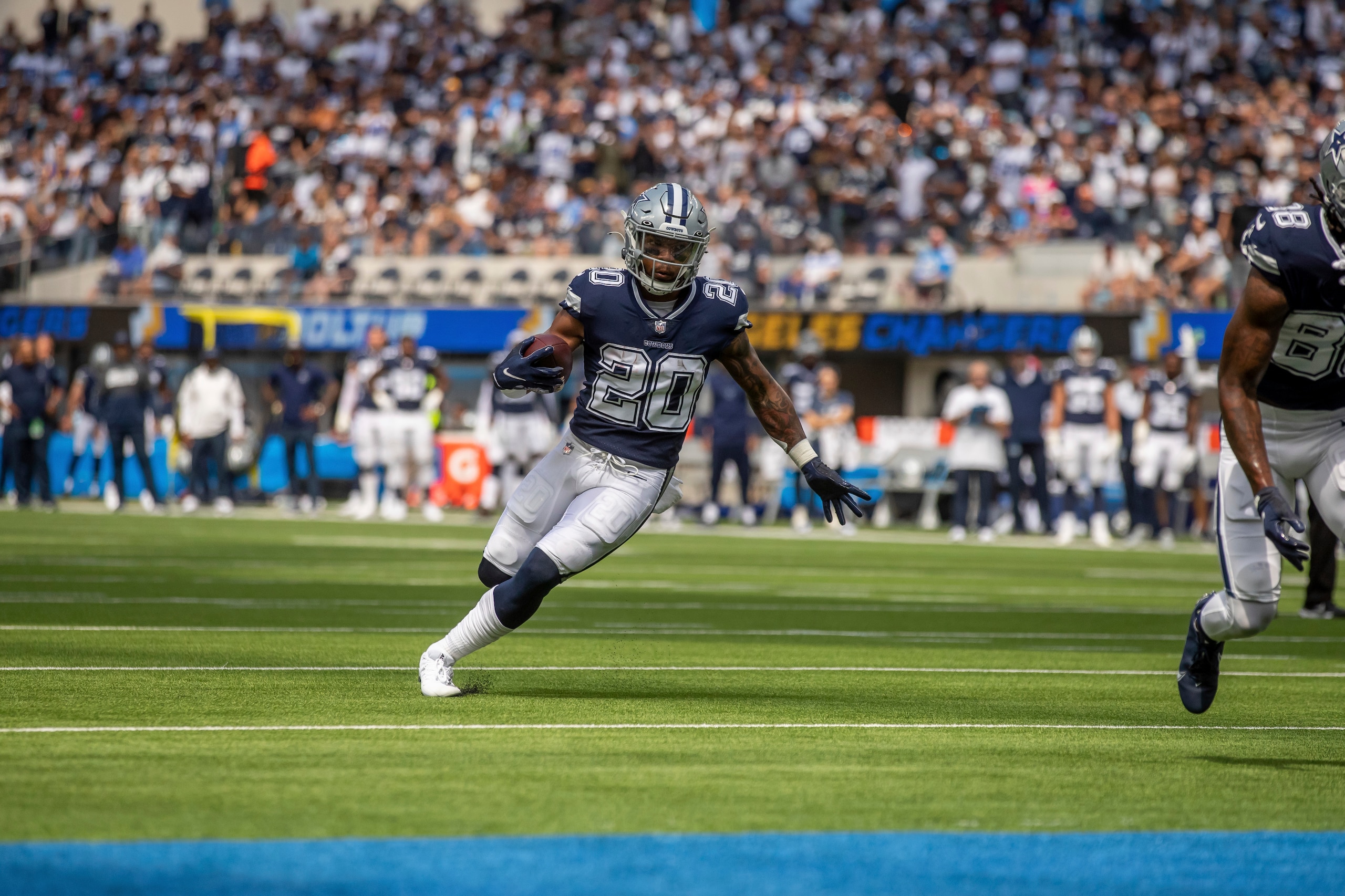 Running back (20) Tony Pollard of the Dallas Cowboys runs and scores a touchdown against the Los Angeles Chargers in an NFL football game, Sunday, Sept. 19, 2021, in Inglewood, Calif. The Cowboys defeated the Chargers 20-17. (AP Photo/Jeff Lewis)