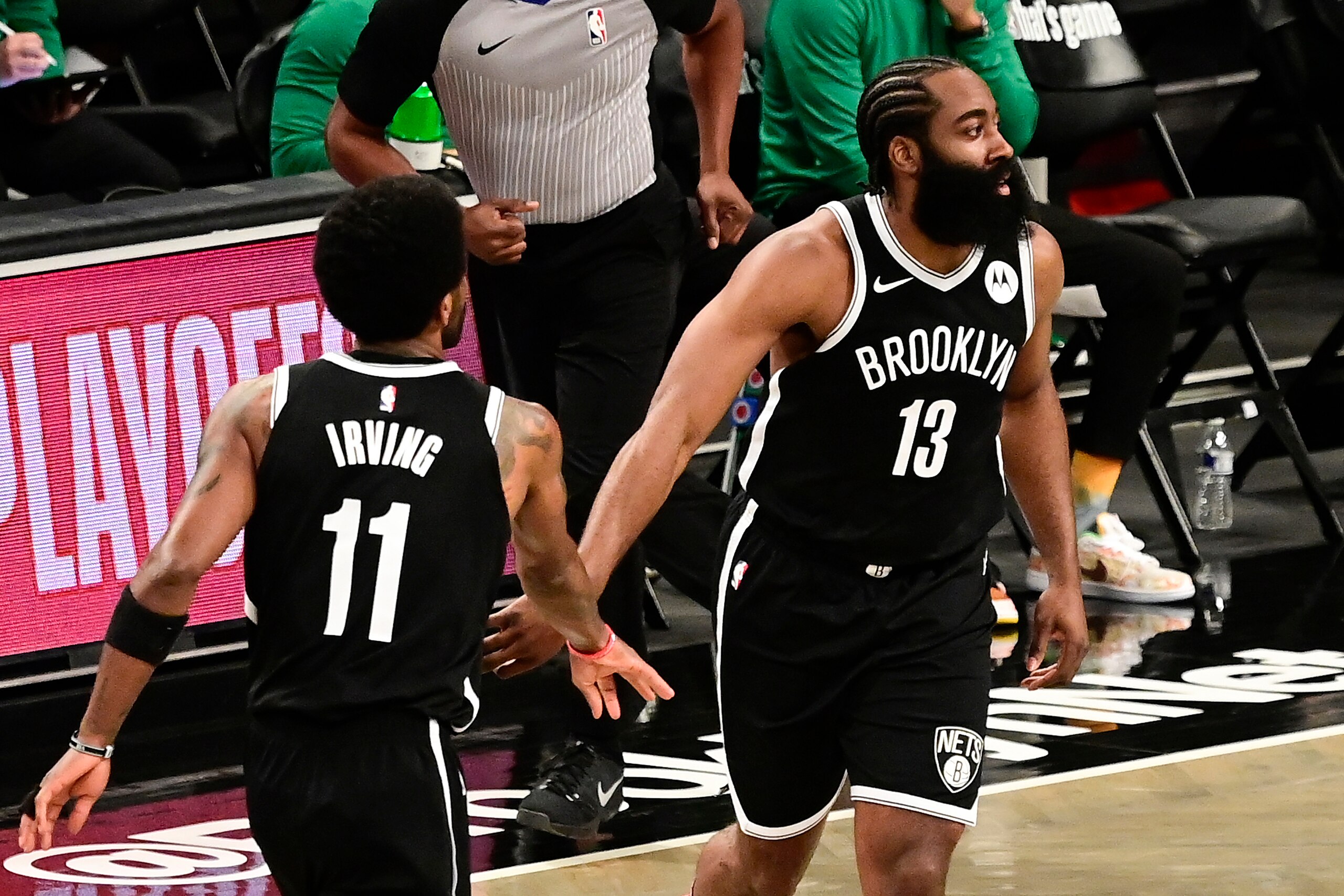 NEW YORK, NEW YORK - MAY 22:  James Harden #13 and Kyrie Irving #11 of the Brooklyn Nets celebrate a basket against the Boston Celtics in Game One of the First Round of the 2021 NBA Playoffs at Barclays Center at Barclays Center on May 22, 2021 in New York City. NOTE TO USER: User expressly acknowledges and agrees that, by downloading and or using this photograph, User is consenting to the terms and conditions of the Getty Images License Agreement.  (Photo by Steven Ryan/Getty Images)