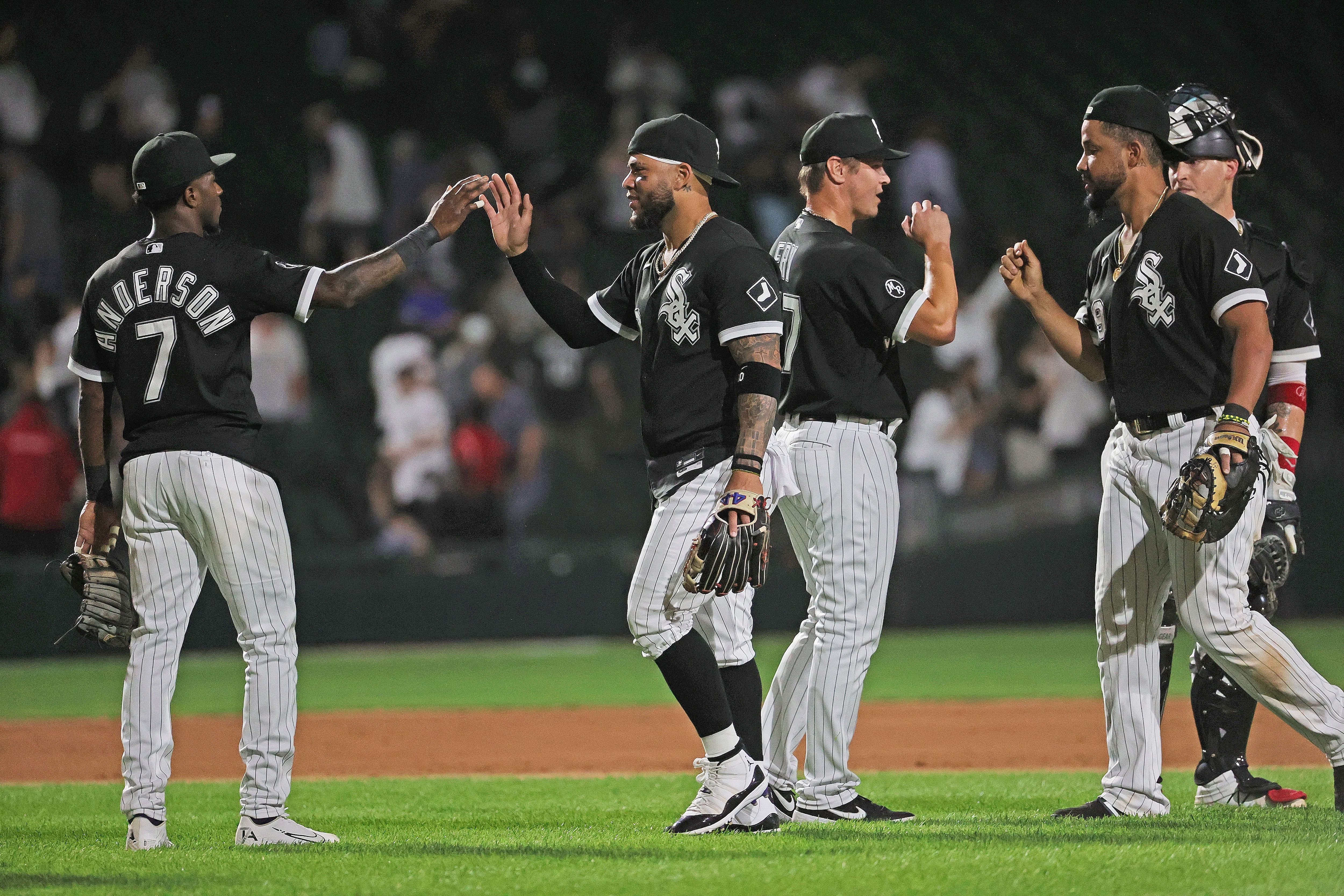CHICAGO, ILLINOIS - SEPTEMBER 14: (L-R) Tim Anderson #7, Yoan Moncada #10, Jace Fry #57 and Jose Abreu #79 of the Chicago White Sox celebrate a win over the Los Angeles Angels at Guaranteed Rate Field on September 14, 2021 in Chicago, Illinois. The White Sox defeated the Angels 9-3. (Photo by Jonathan Daniel/Getty Images)
