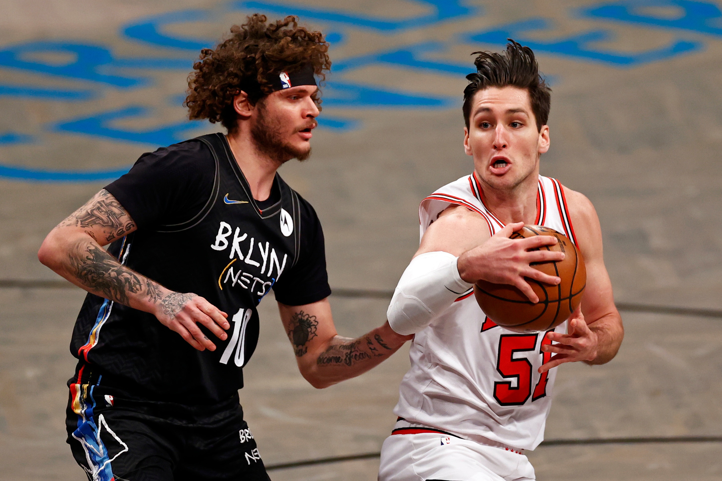 Chicago Bulls guard Ryan Arcidiacono (51) drives to the basket past Brooklyn Nets guard Tyler Johnson during the first half of an NBA basketball game Saturday, May 15, 2021, in New York. (AP Photo/Adam Hunger)