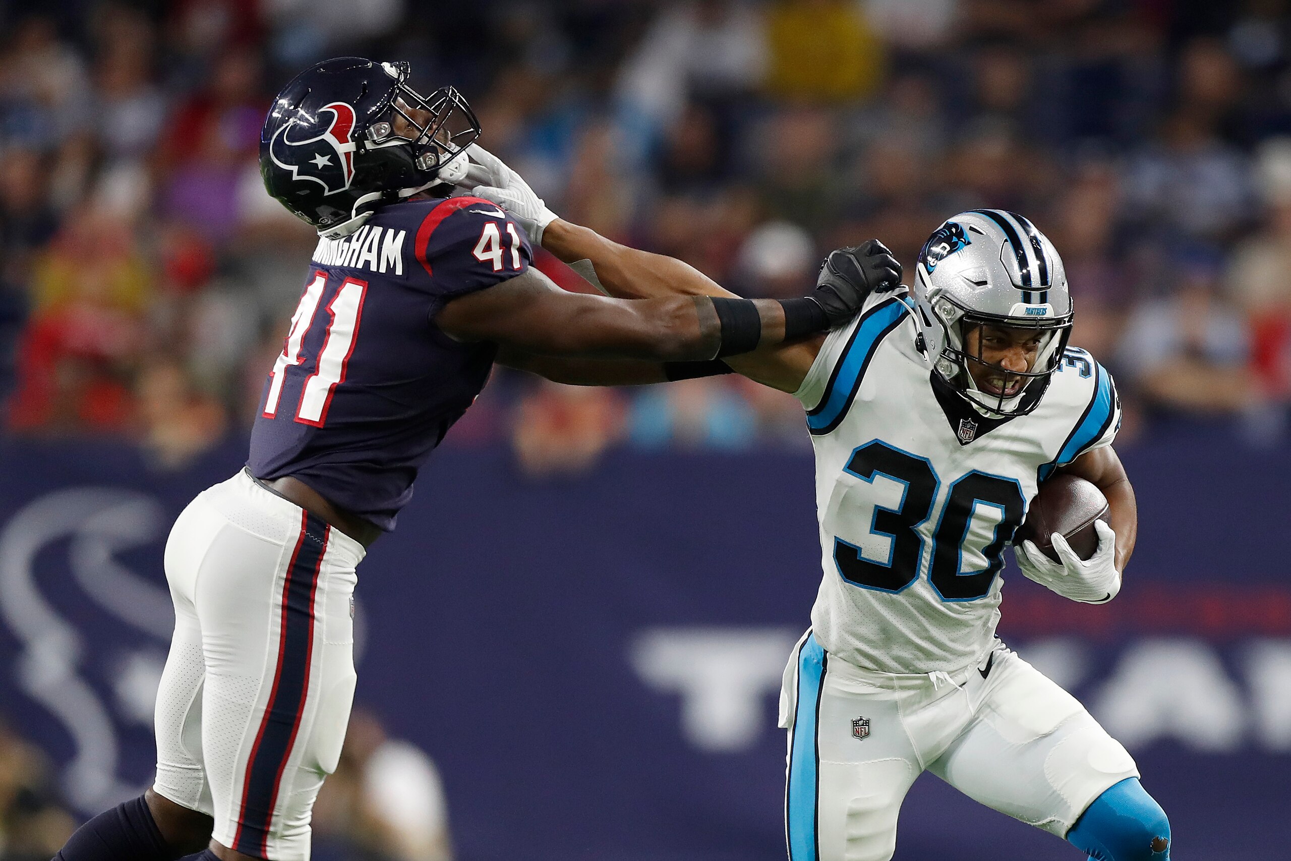 HOUSTON, TEXAS - SEPTEMBER 23: Chuba Hubbard #30 of the Carolina Panthers tries to hold off the tackle of Zach Cunningham #41 of the Houston Texans during a first half run at NRG Stadium on September 23, 2021 in Houston, Texas. (Photo by Tim Warner/Getty Images)