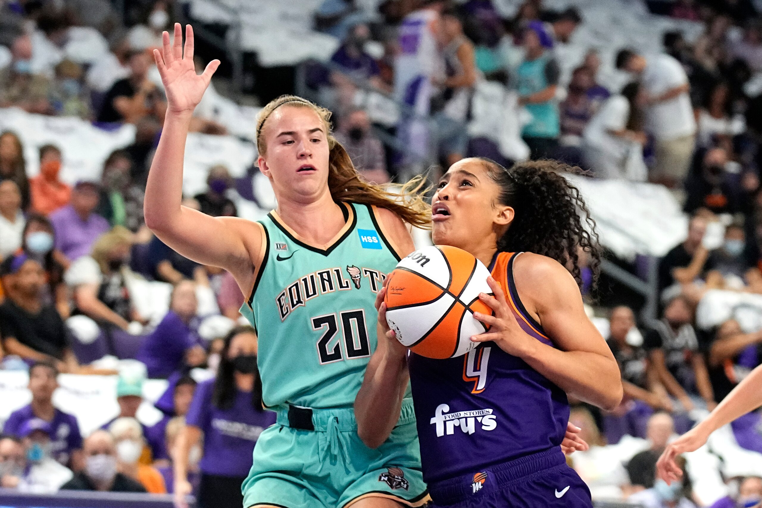 Phoenix Mercury guard Skylar Diggins-Smith drives past New York Liberty guard Sabrina Ionescu (20) during the first half in the first round of the WNBA basketball playoffs, Thursday, Sept. 23, 2021, in Phoenix. (AP Photo/Rick Scuteri)