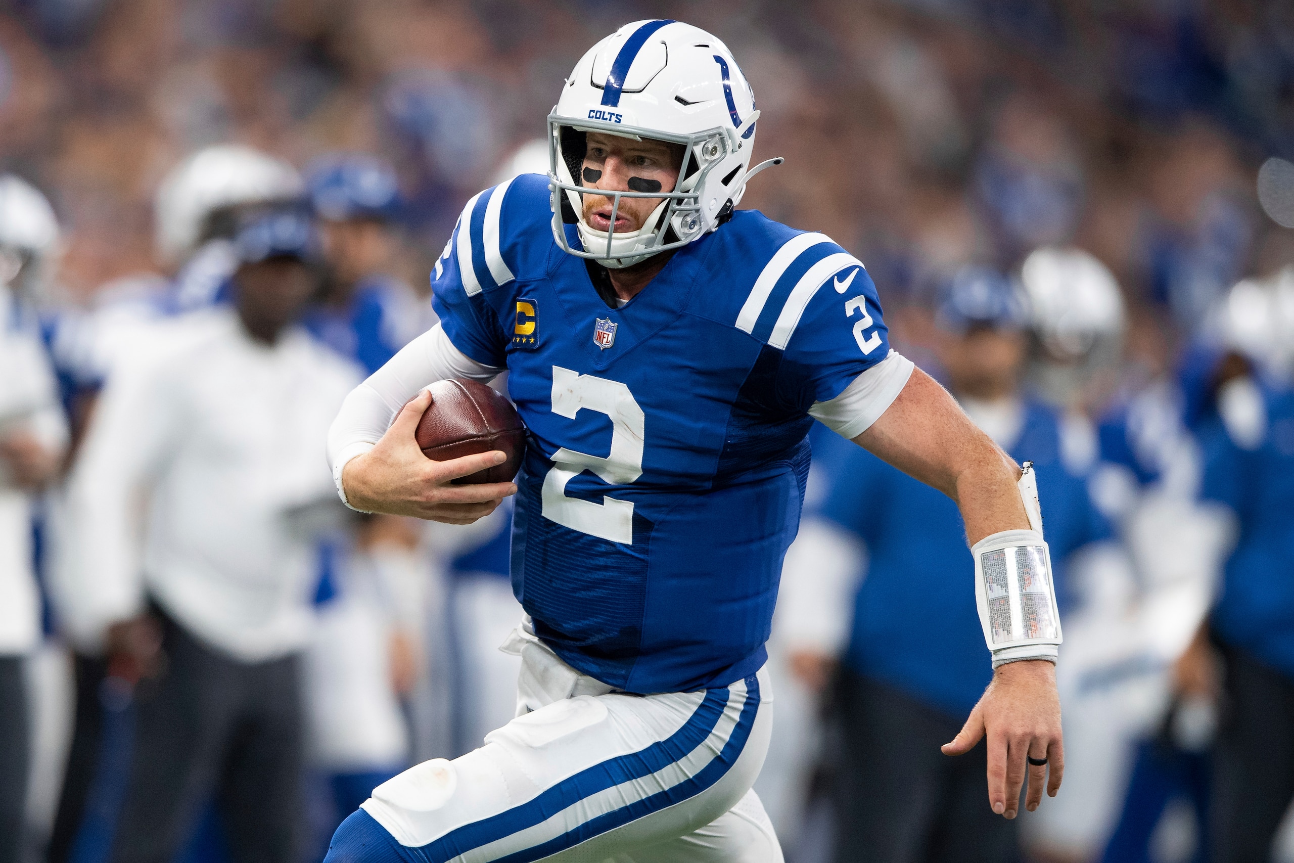 Indianapolis Colts quarterback Carson Wentz (2) scrambles from pressure during an NFL football game against the Los Angeles Rams, Sunday, Sept. 19, 2021, in Indianapolis. (AP Photo/Zach Bolinger)
