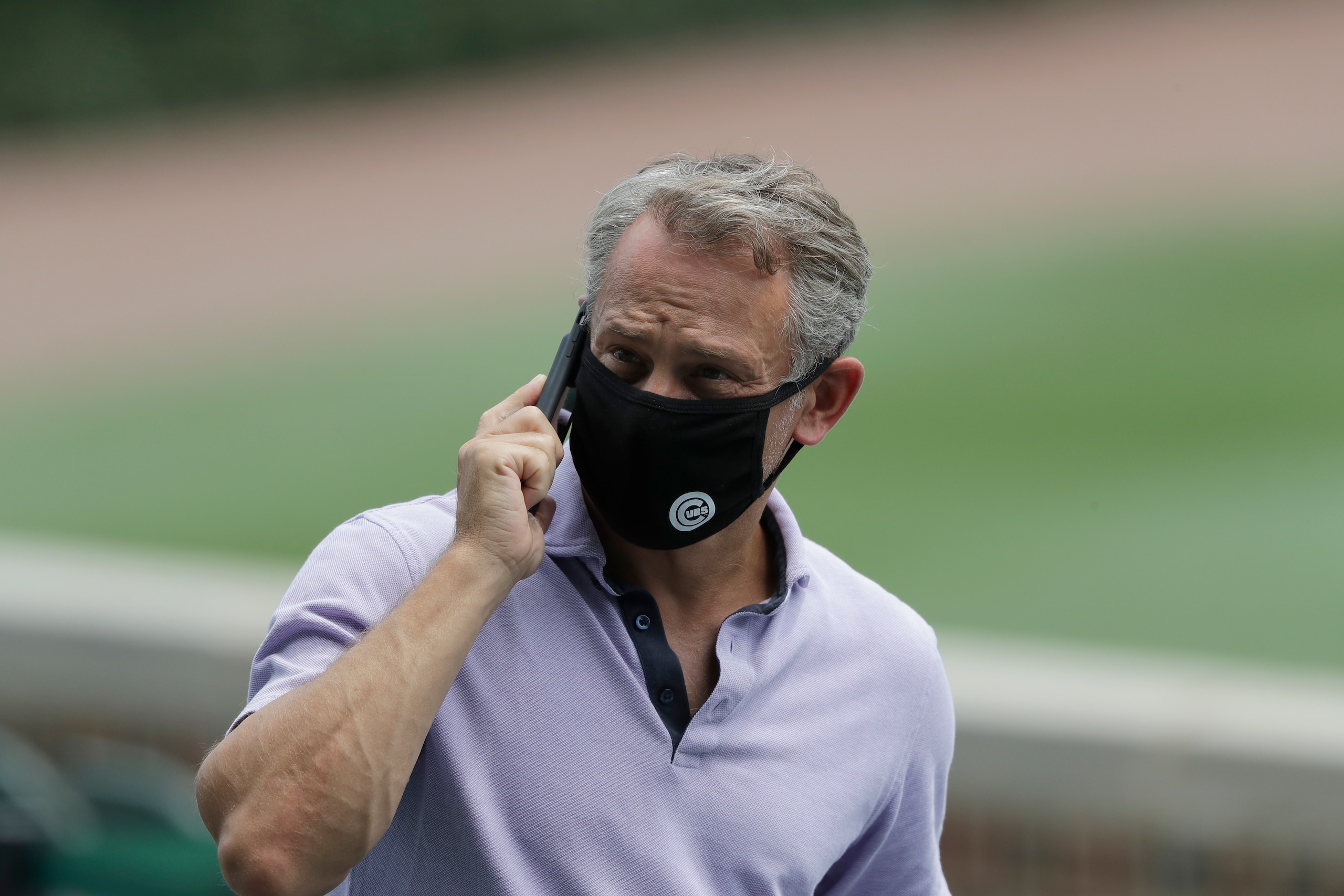 Chicago Cubs general manager Jed Hoyer talks on the phone during team's baseball practice at Wrigley Field in Chicago, Wednesday, July 8, 2020. (AP Photo/Nam Y. Huh)