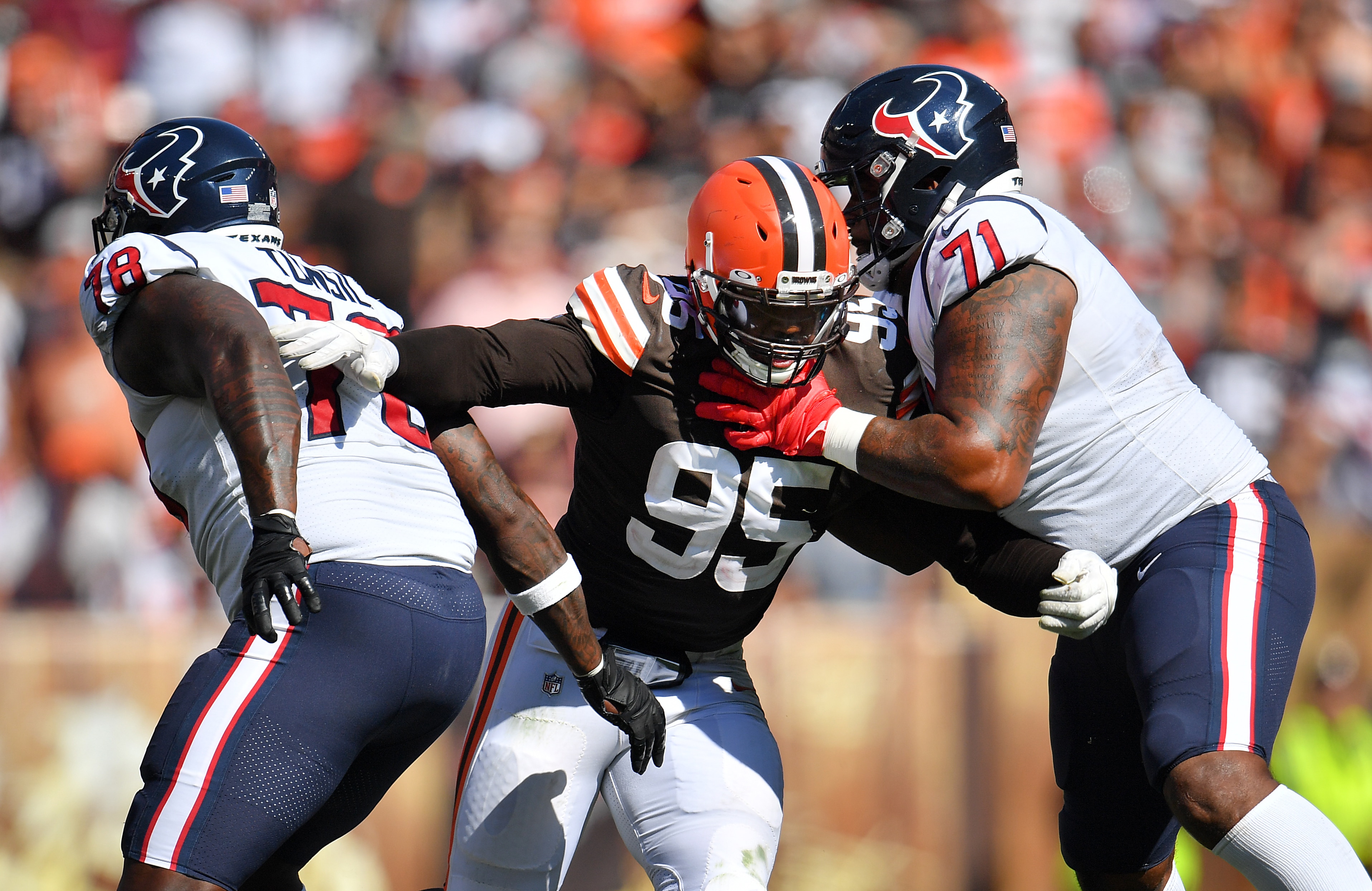 CLEVELAND, OHIO - SEPTEMBER 19: Defensive end Myles Garrett #95 of the Cleveland Browns battles offensive tackle Laremy Tunsil #78 and offensive tackle Tytus Howard #71 of the Houston Texans during the second half at FirstEnergy Stadium on September 19, 2021 in Cleveland, Ohio. (Photo by Jason Miller/Getty Images)