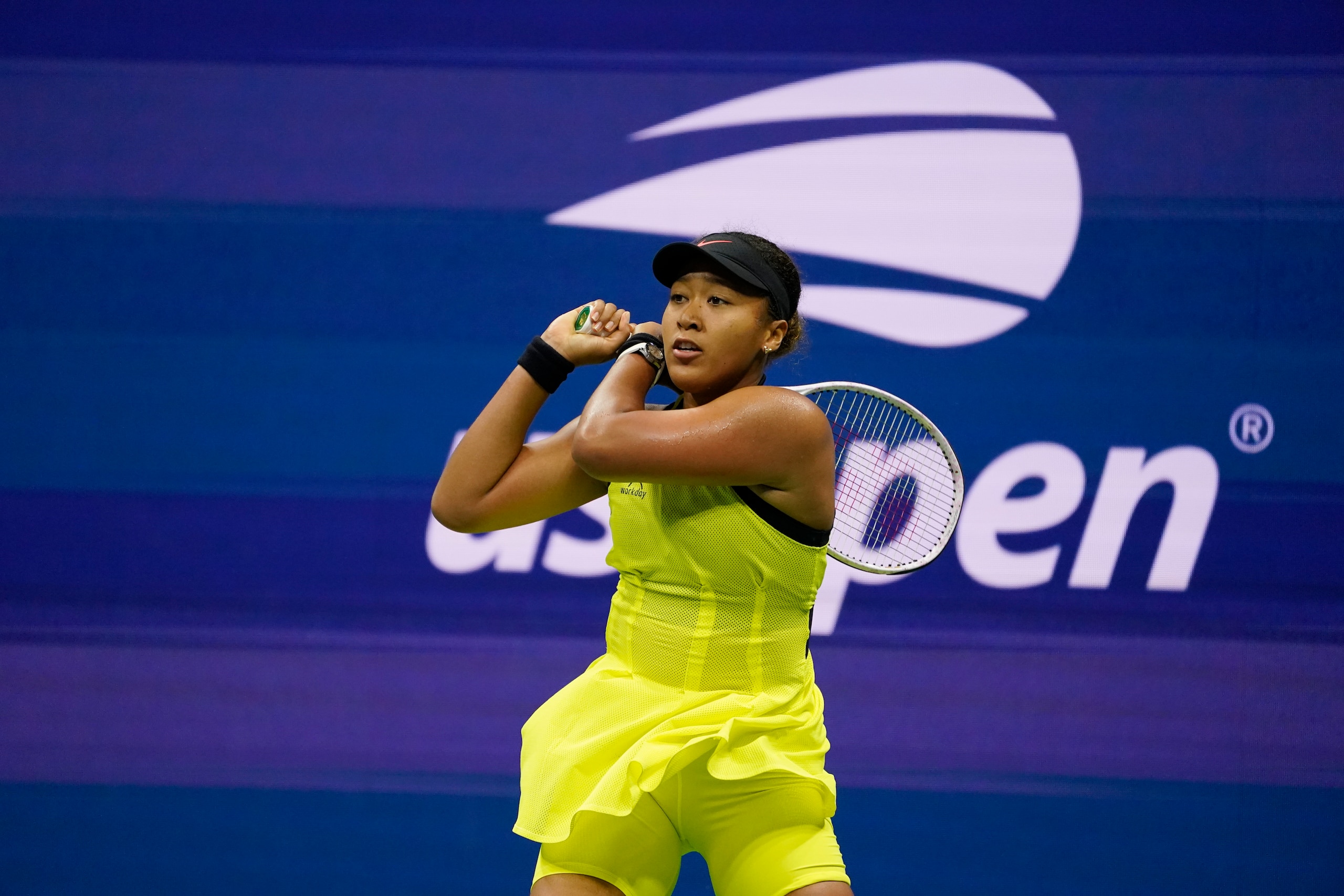 Naomi Osaka, of Japan, returns a shot to Leylah Fernandez, of Canada, during the third round of the US Open tennis championships, Friday, Sept. 3, 2021, in New York. (AP Photo/John Minchillo)