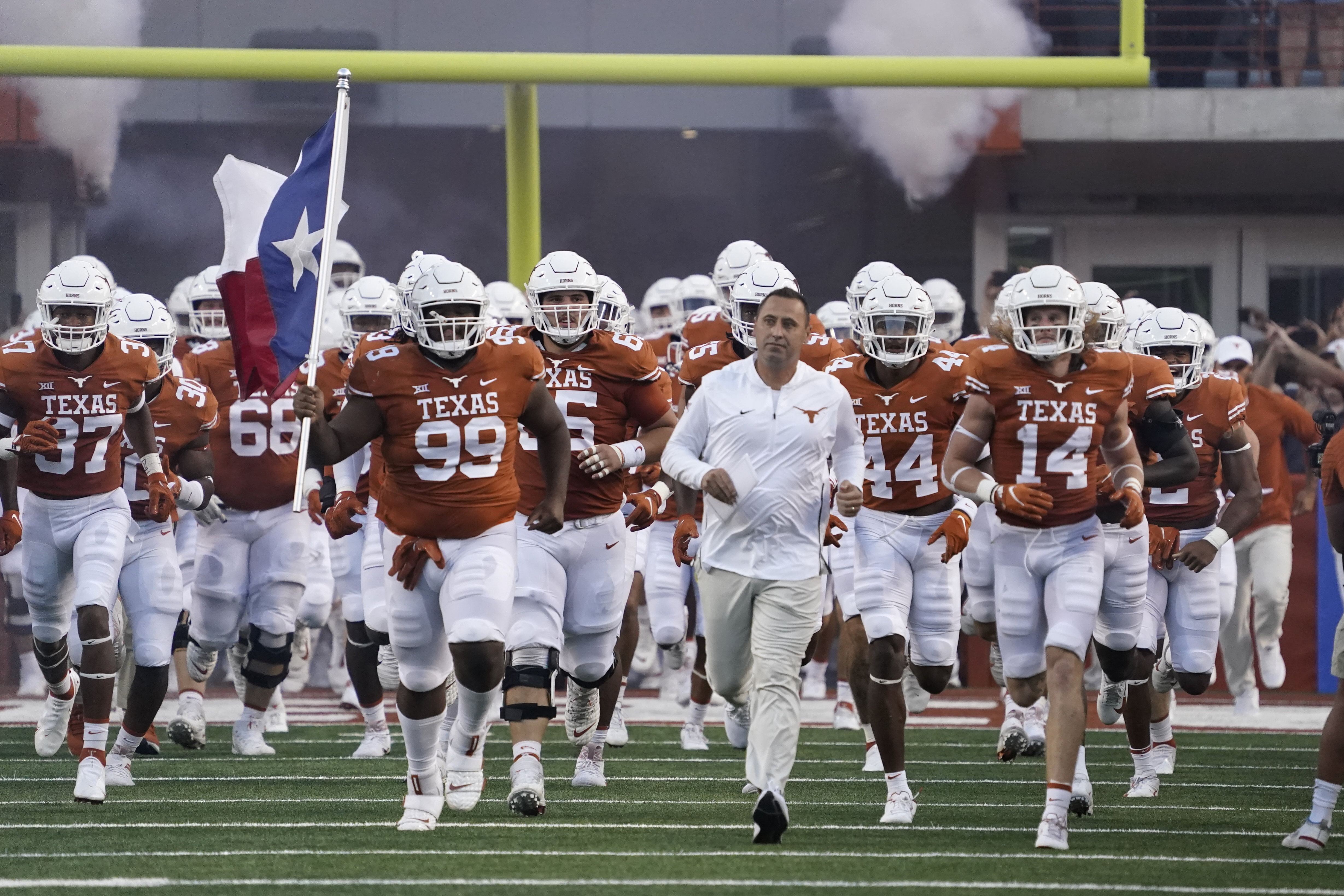 Texas players take the field led by Texas head coach Steve Sarkisian before an NCAA college football game against Rice on Saturday, Sept. 18, 2021, in Austin, Texas. (AP Photo/Chuck Burton)