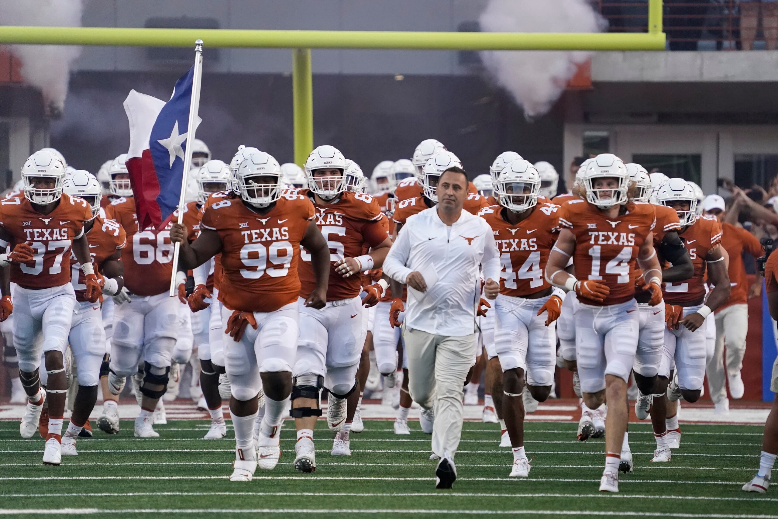 Texas players take the field led by Texas head coach Steve Sarkisian before an NCAA college football game against Rice on Saturday, Sept. 18, 2021, in Austin, Texas. (AP Photo/Chuck Burton) Texas players take the field led by Texas head coach Steve Sarkisian before an NCAA college football game against Rice on Saturday, Sept. 18, 2021, in Austin, Texas. (AP Photo/Chuck Burton)
