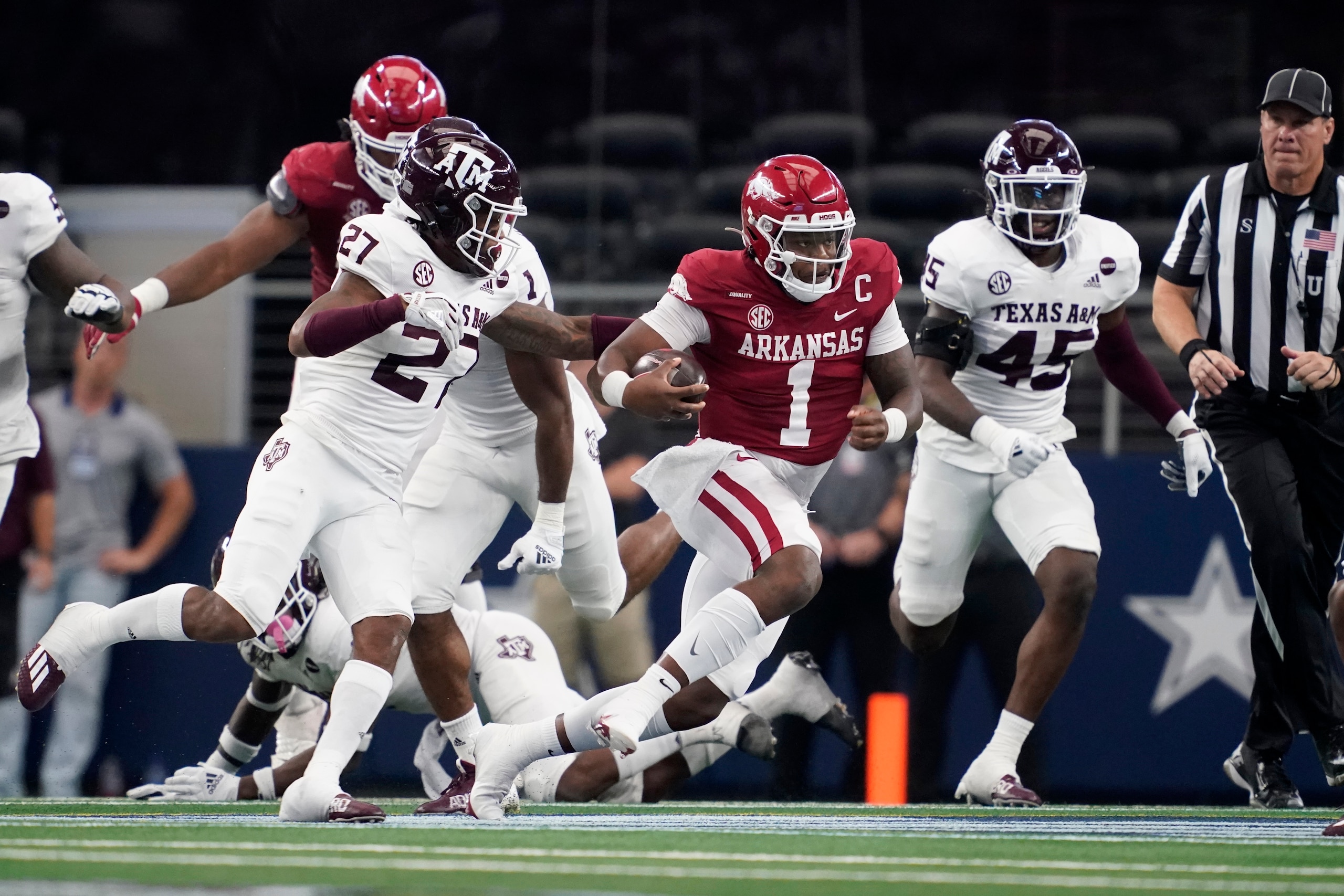 Arkansas quarterback KJ Jefferson (1) finds running room as Texas A&M defensive back Antonio Johnson (27) and linebacker Edgerrin Cooper (45) give chase in the first half of an NCAA college football game in Arlington, Texas, Saturday, Sept. 25, 2021. (AP Photo/Tony Gutierrez)