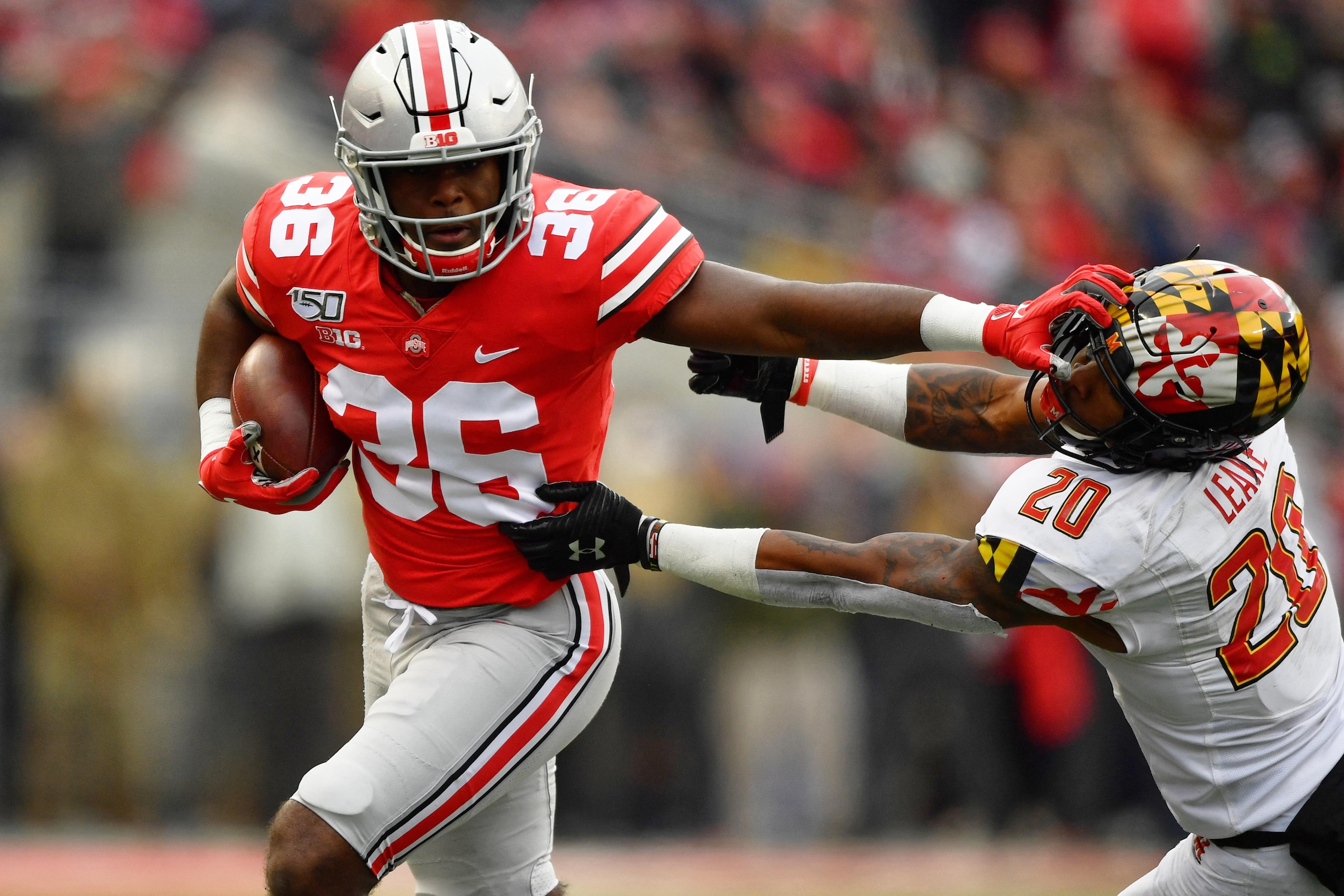 COLUMBUS, OH - NOVEMBER 9:  K'Vaughan Pope #36 of the Ohio State Buckeyes stiff arms Javon Leake #20 of the Maryland Terrapins after intercepting a pass in the third quarter at Ohio Stadium on November 9, 2019 in Columbus, Ohio. Ohio State defeated Maryland 73-14.  (Photo by Jamie Sabau/Getty Images)