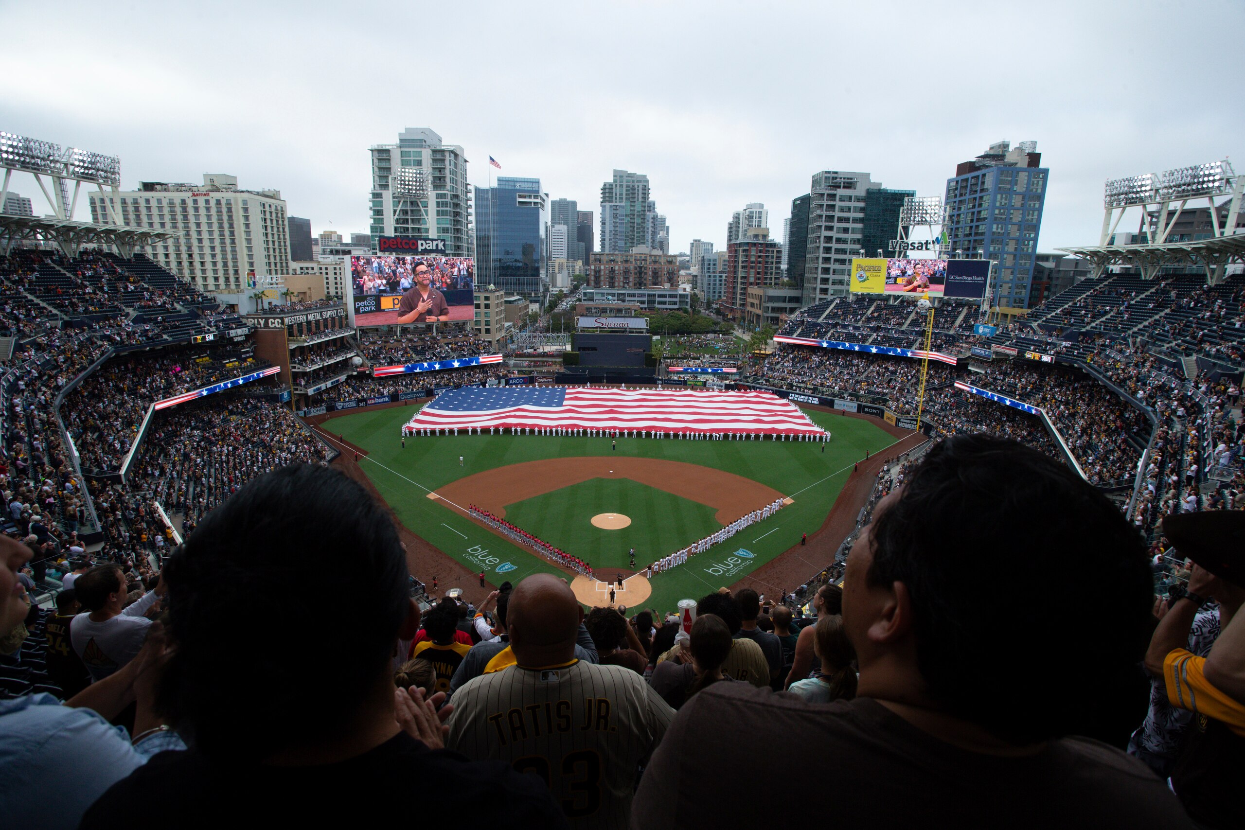 A giant American flag is displayed during the national anthem prior to a baseball game between the San Diego Padres and the Cincinnati Reds Thursday, June 17, 2021, in San Diego. Petco Park opened up for full capacity viewing of a baseball game without masks for the first time since the 2019 season. (AP Photo/Derrick Tuskan) A giant American flag is displayed during the national anthem prior to a baseball game between the San Diego Padres and the Cincinnati Reds Thursday, June 17, 2021, in San Diego. Petco Park opened up for full capacity viewing of a baseball game without masks for the first time since the 2019 season. (AP Photo/Derrick Tuskan)