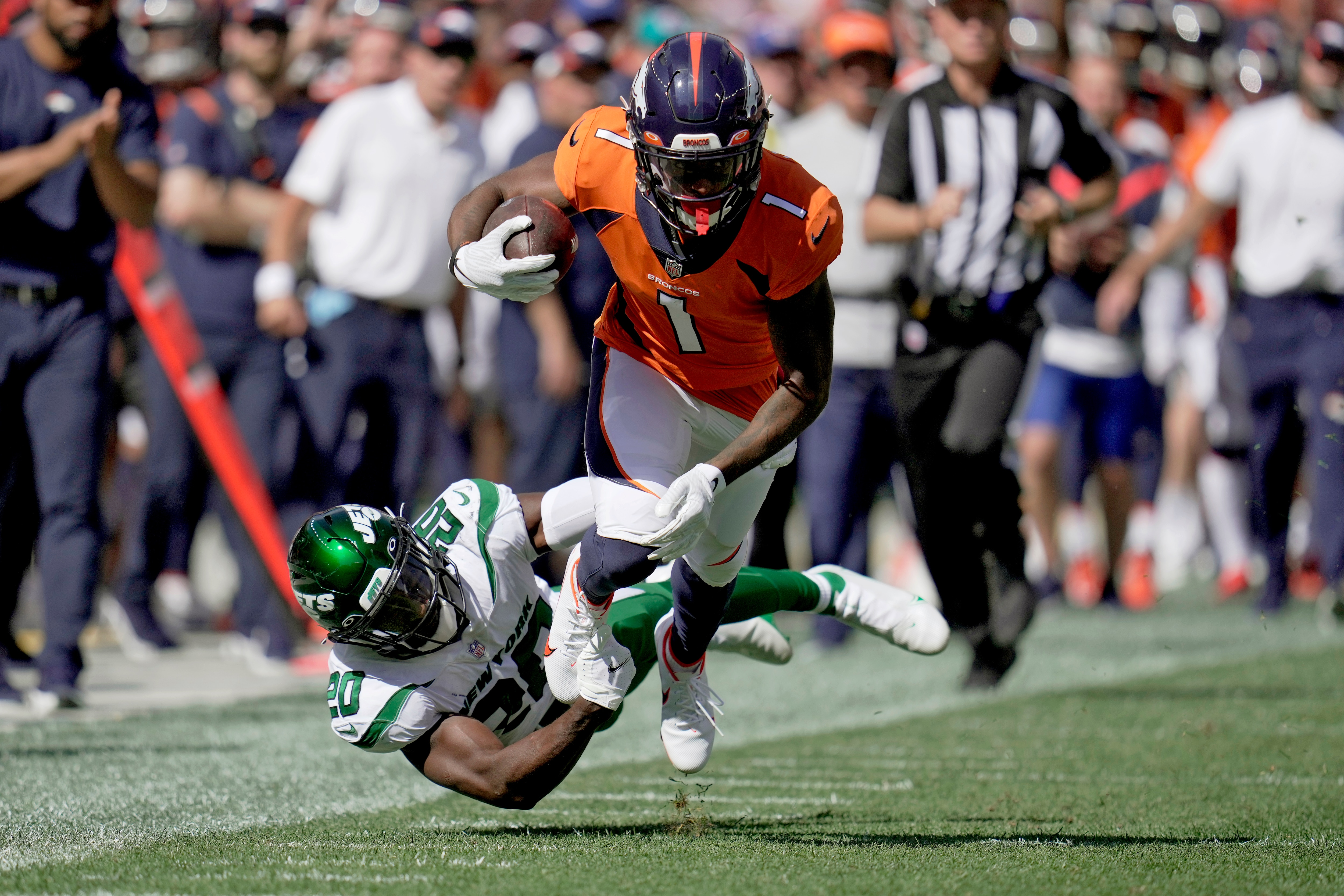 Denver Broncos wide receiver K.J. Hamler (1) is tackled by New York Jets free safety Marcus Maye (20) during the first half of an NFL football game, Sunday, Sept. 26, 2021, in Denver. (AP Photo/Jack Dempsey)