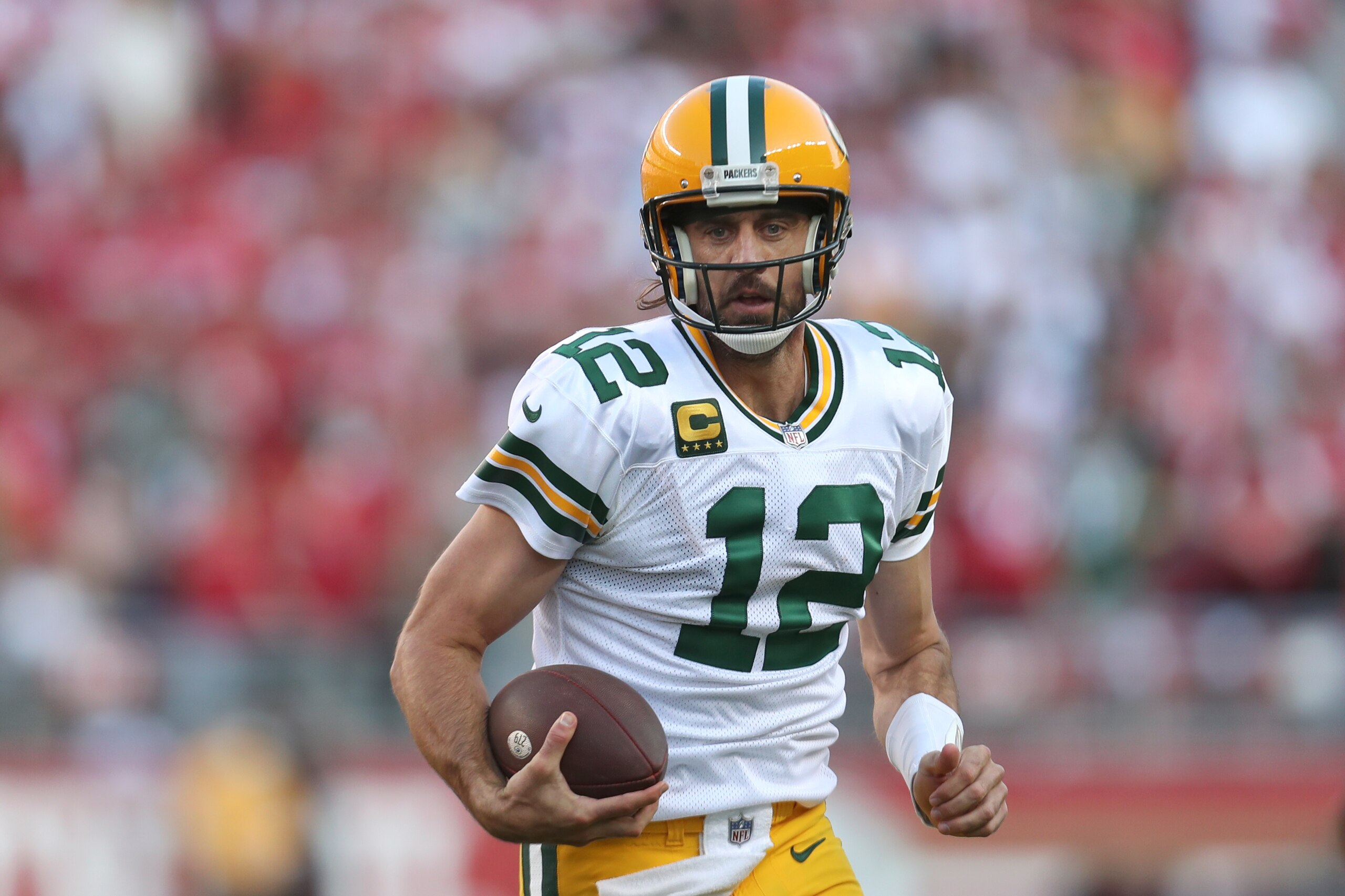 Green Bay Packers quarterback Aaron Rodgers (12) scrambles against the San Francisco 49ers during the first half of an NFL football game in Santa Clara, Calif., Sunday, Sept. 26, 2021. (AP Photo/Jed Jacobsohn)