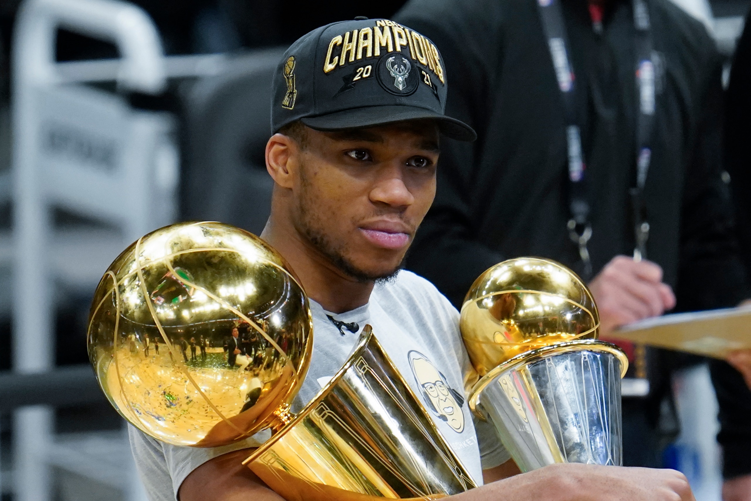 Milwaukee Bucks forward Giannis Antetokounmpo holds the NBA Championship trophy, left, and Most Valuable Player trophy after defeating the Phoenix Suns in Game 6 of basketball's NBA Finals in Milwaukee, Tuesday, July 20, 2021. The Bucks won 105-98. (AP Photo/Paul Sancya) Milwaukee Bucks forward Giannis Antetokounmpo holds the NBA Championship trophy, left, and Most Valuable Player trophy after defeating the Phoenix Suns in Game 6 of basketball's NBA Finals in Milwaukee, Tuesday, July 20, 2021. The Bucks won 105-98. (AP Photo/Paul Sancya)
