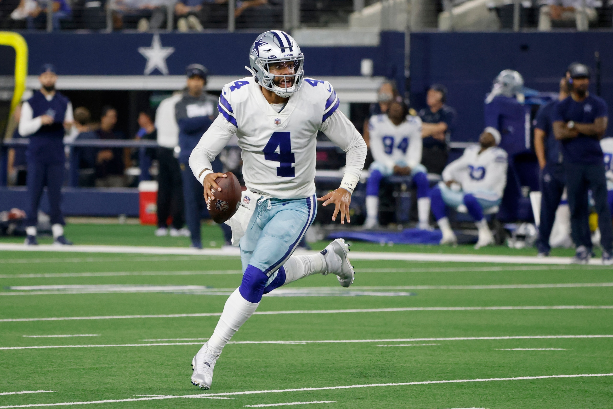 Dallas Cowboys quarterback Dak Prescott (4) runs the ball out of the pocket before throwing a pass in the first half of an NFL football game against the Philadelphia Eagles in Arlington, Texas, Monday, Sept. 27, 2021. (AP Photo/Michael Ainsworth)