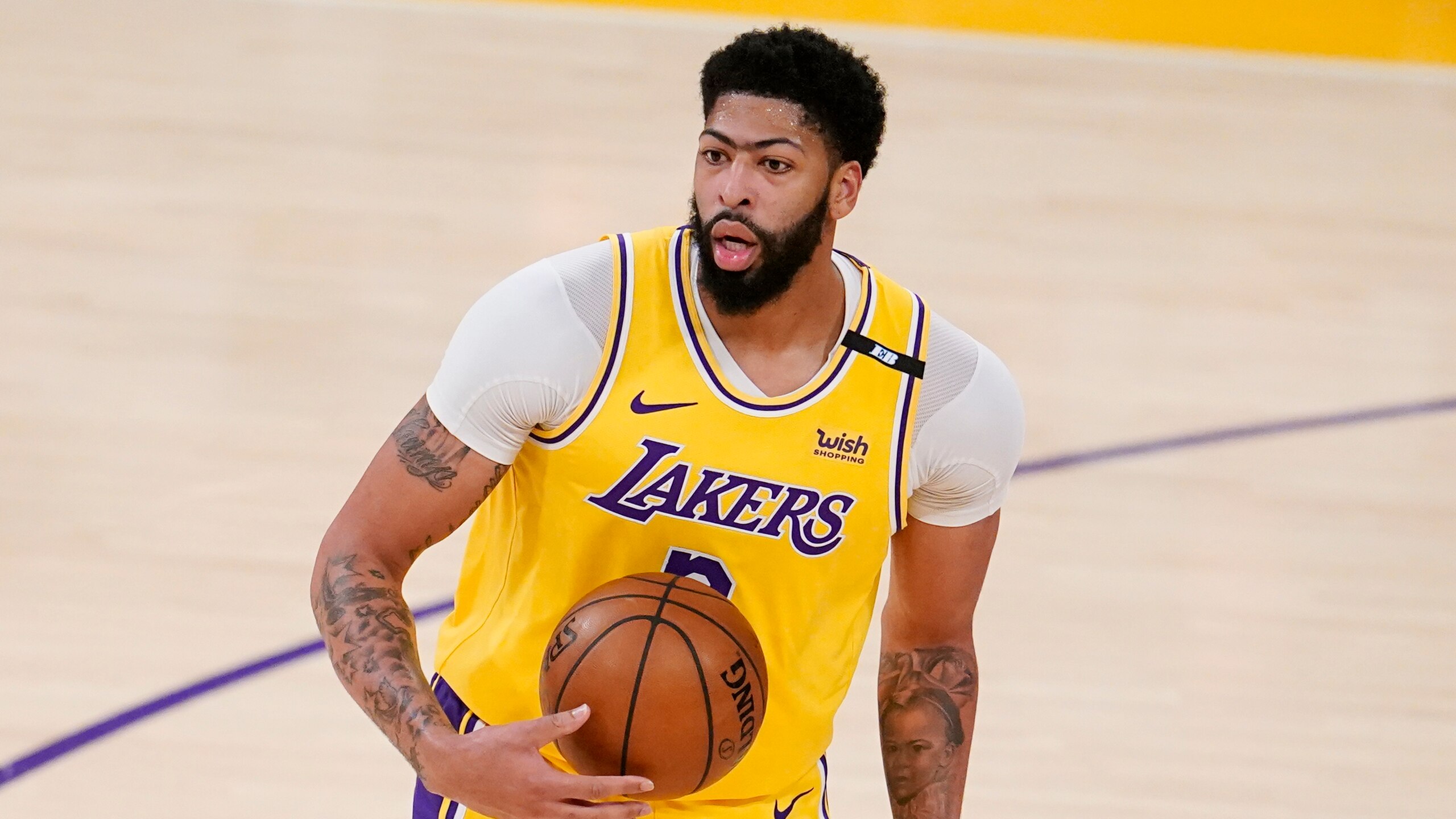 Los Angeles Lakers forward Anthony Davis holds the ball during Game 3 of an NBA basketball first-round playoff series against the Phoenix Suns Thursday, May 27, 2021, in Los Angeles. (AP Photo/Marcio Jose Sanchez)