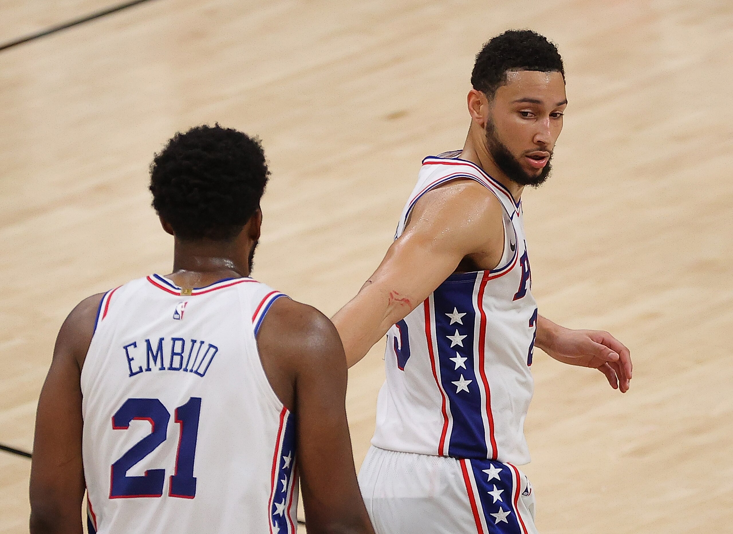 ATLANTA, GEORGIA - JUNE 14:  Ben Simmons #25 of the Philadelphia 76ers reacts towards Joel Embiid #21 during the second half of game 4 of the Eastern Conference Semifinals against the Atlanta Hawks at State Farm Arena on June 14, 2021 in Atlanta, Georgia.  NOTE TO USER: User expressly acknowledges and agrees that, by downloading and or using this photograph, User is consenting to the terms and conditions of the Getty Images License Agreement. (Photo by Kevin C. Cox/Getty Images)