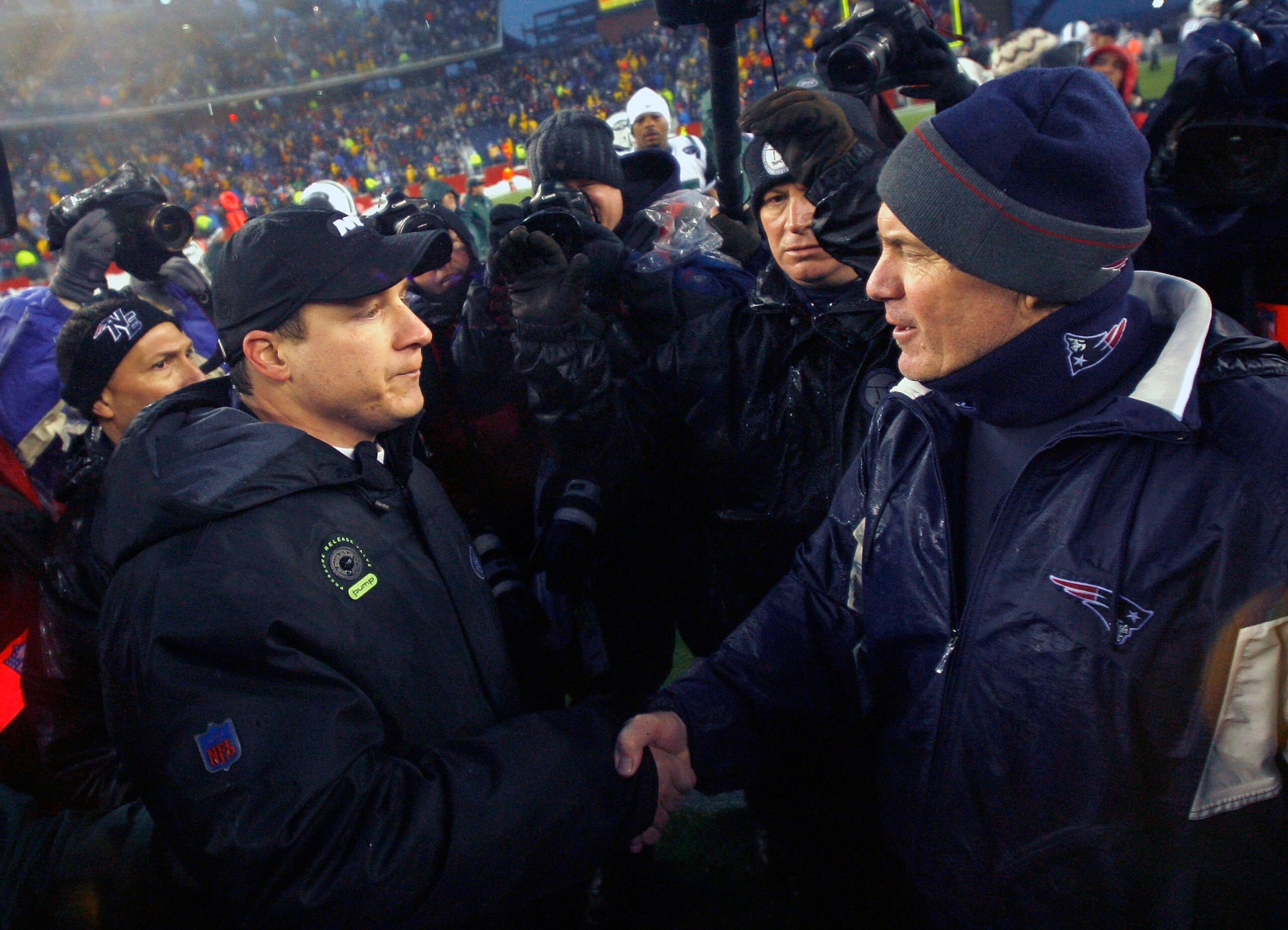FOXBORO, MA - DECEMBER 16: Coach Bill Belichick of the New England Patriots shakes hands with coach Eric Mangini of the New York Jets at Gillette Stadium on December 16, 2007 in Foxboro, Massachusetts. The Patriots won 20-10. (Photo by Jim Rogash/Getty Images) FOXBORO, MA - DECEMBER 16: Coach Bill Belichick of the New England Patriots shakes hands with coach Eric Mangini of the New York Jets at Gillette Stadium on December 16, 2007 in Foxboro, Massachusetts. The Patriots won 20-10. (Photo by Jim Rogash/Getty Images)