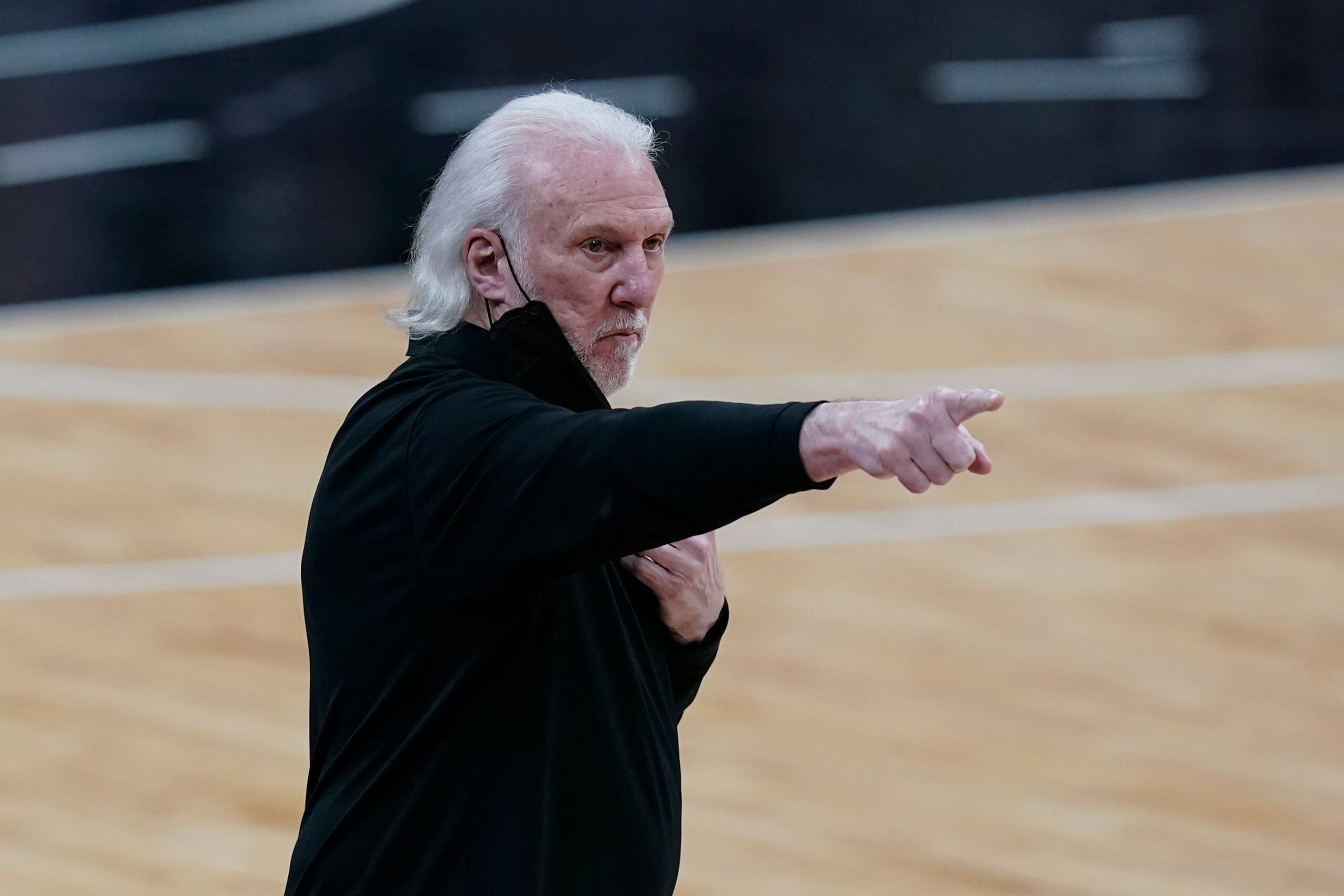 San Antonio Spurs head coach Gregg Popovich talks to his players during the first half of an NBA basketball game against the Miami Heat in San Antonio, Wednesday, April 21, 2021. (AP Photo/Eric Gay)