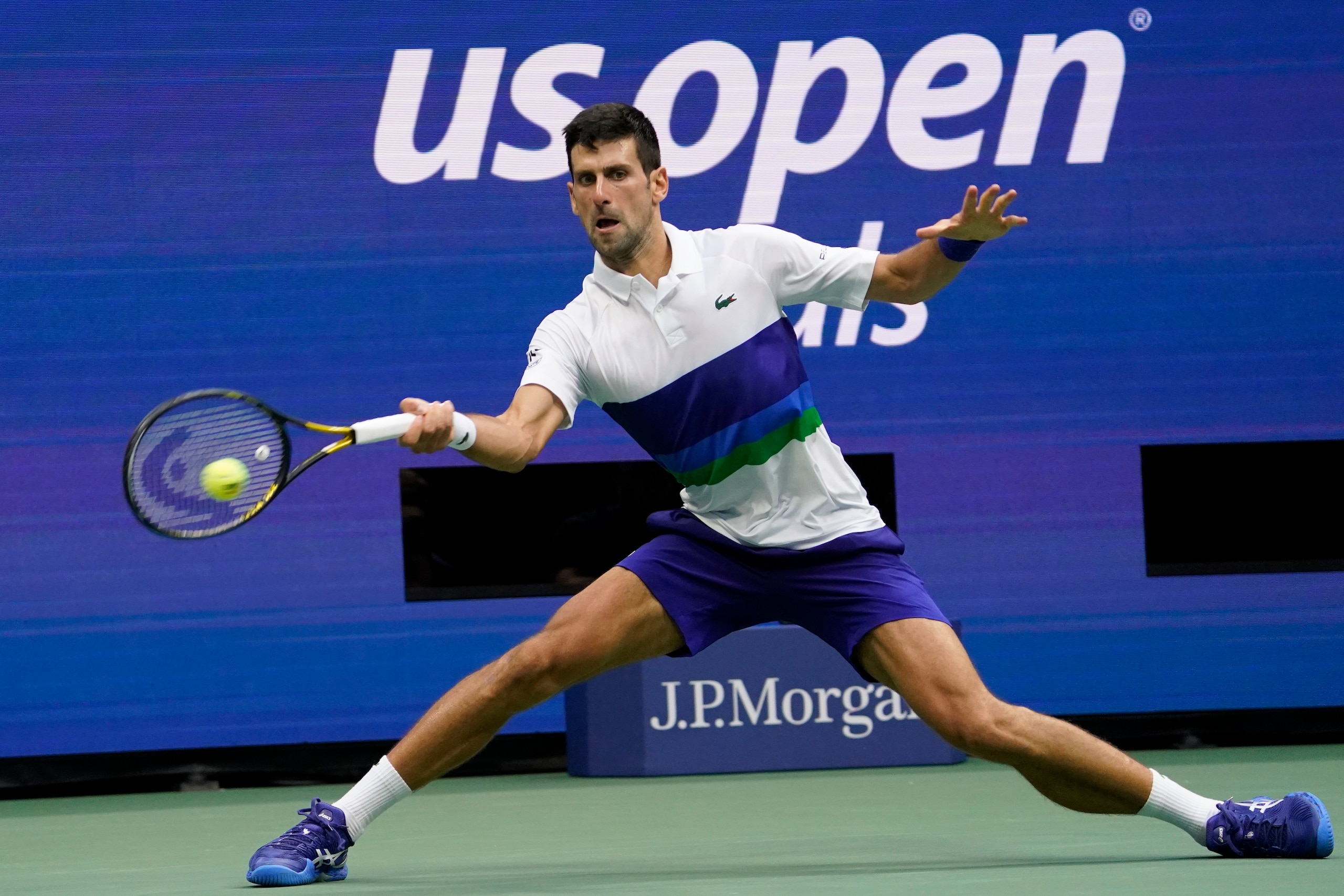 Novak Djokovic, of Serbia, returns to Daniil Medvedev, of Russia, during the men's singles final of the US Open tennis championships, Sunday, Sept. 12, 2021, in New York. (AP Photo/John Minchillo)