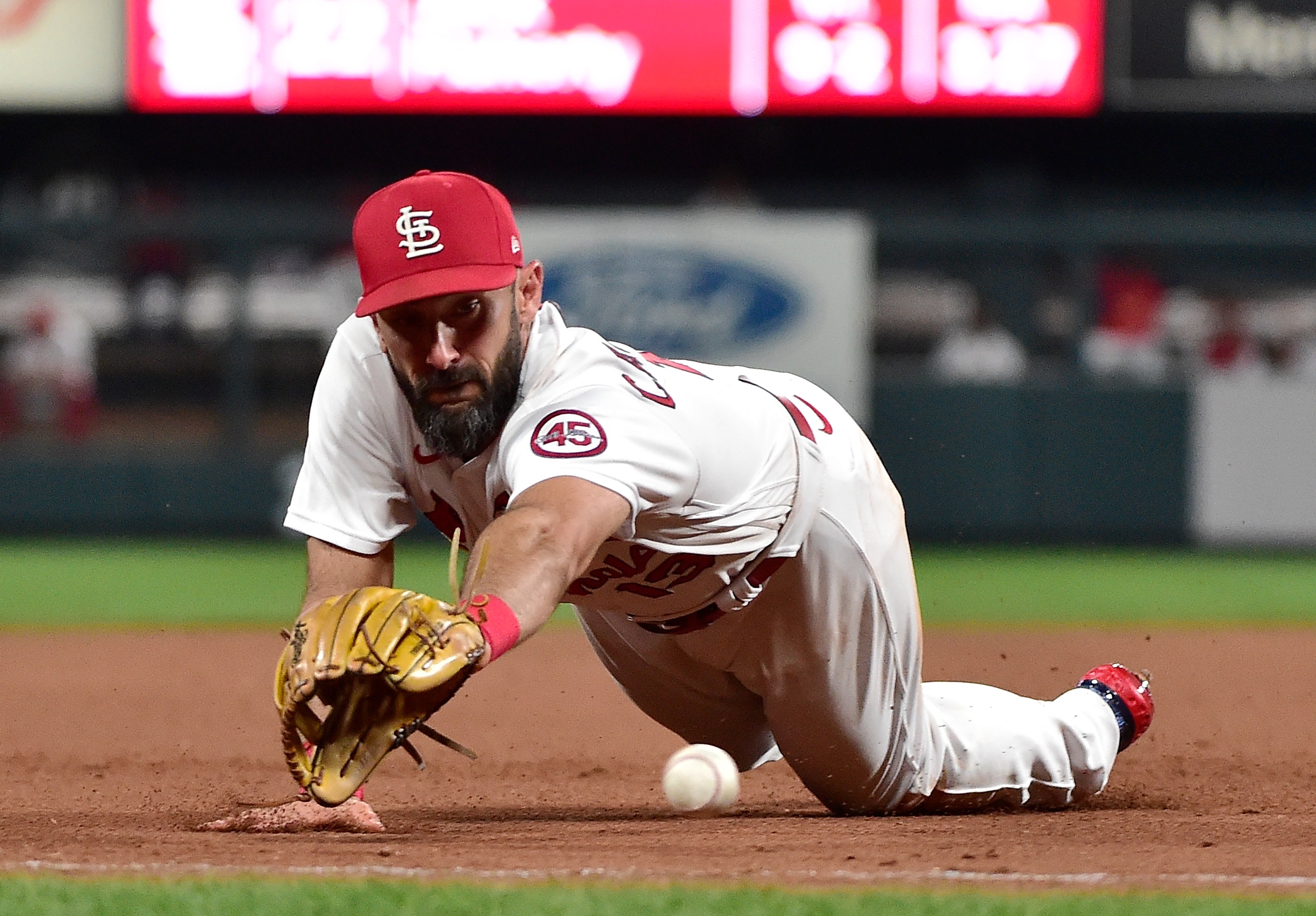 ST LOUIS, MO - SEPTEMBER 29:  Matt Carpenter #13 of the St. Louis Cardinals dives for a ground ball during the eighth inning against the Milwaukee Brewers at Busch Stadium on September 29, 2021 in St Louis, Missouri. (Photo by Jeff Curry/Getty Images)