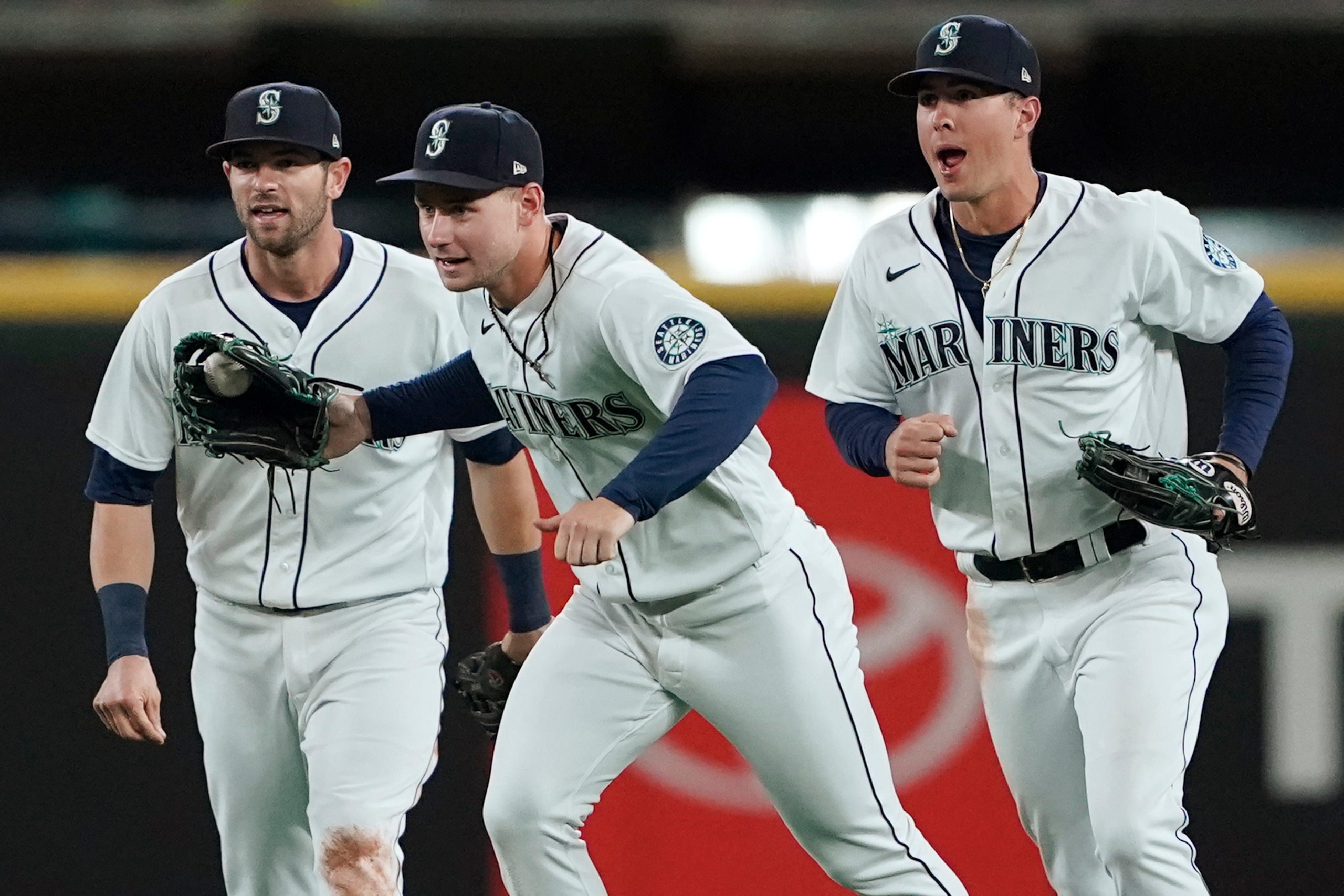 Seattle Mariners outfielders, from left, Mitch Haniger, Jarred Kelenic, and Dylan Moore celebrate after the Mariners beat the Oakland Athletics 4-2 in a baseball game, Wednesday, Sept. 29, 2021, in Seattle. (AP Photo/Ted S. Warren) Seattle Mariners outfielders, from left, Mitch Haniger, Jarred Kelenic, and Dylan Moore celebrate after the Mariners beat the Oakland Athletics 4-2 in a baseball game, Wednesday, Sept. 29, 2021, in Seattle. (AP Photo/Ted S. Warren)