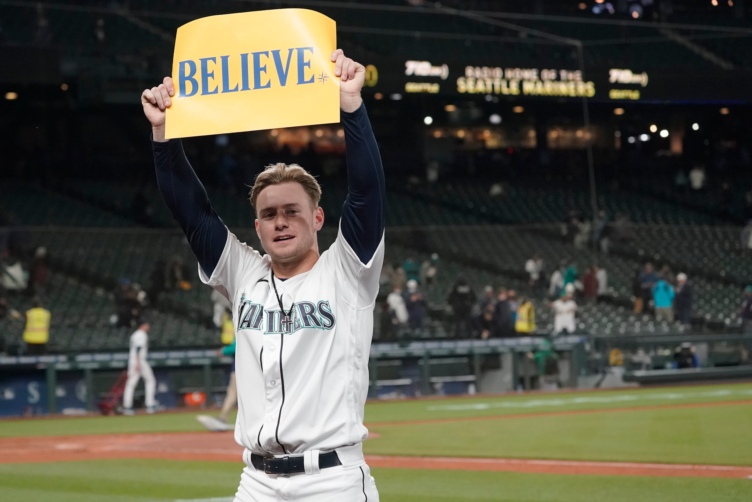 Seattle Mariners' Jarred Kelenic holds up a sign that read "Believe" after the Mariners beat the Oakland Athletics 4-2 in a baseball game, Wednesday, Sept. 29, 2021, in Seattle. Fans and the team have adopted the one-word slogan that was recently featured on the TV series "Ted Lasso" as the Mariners battle for a spot in the MLB playoffs. (AP Photo/Ted S. Warren) Seattle Mariners' Jarred Kelenic holds up a sign that read "Believe" after the Mariners beat the Oakland Athletics 4-2 in a baseball game, Wednesday, Sept. 29, 2021, in Seattle. Fans and the team have adopted the one-word slogan that was recently featured on the TV series "Ted Lasso" as the Mariners battle for a spot in the MLB playoffs. (AP Photo/Ted S. Warren)
