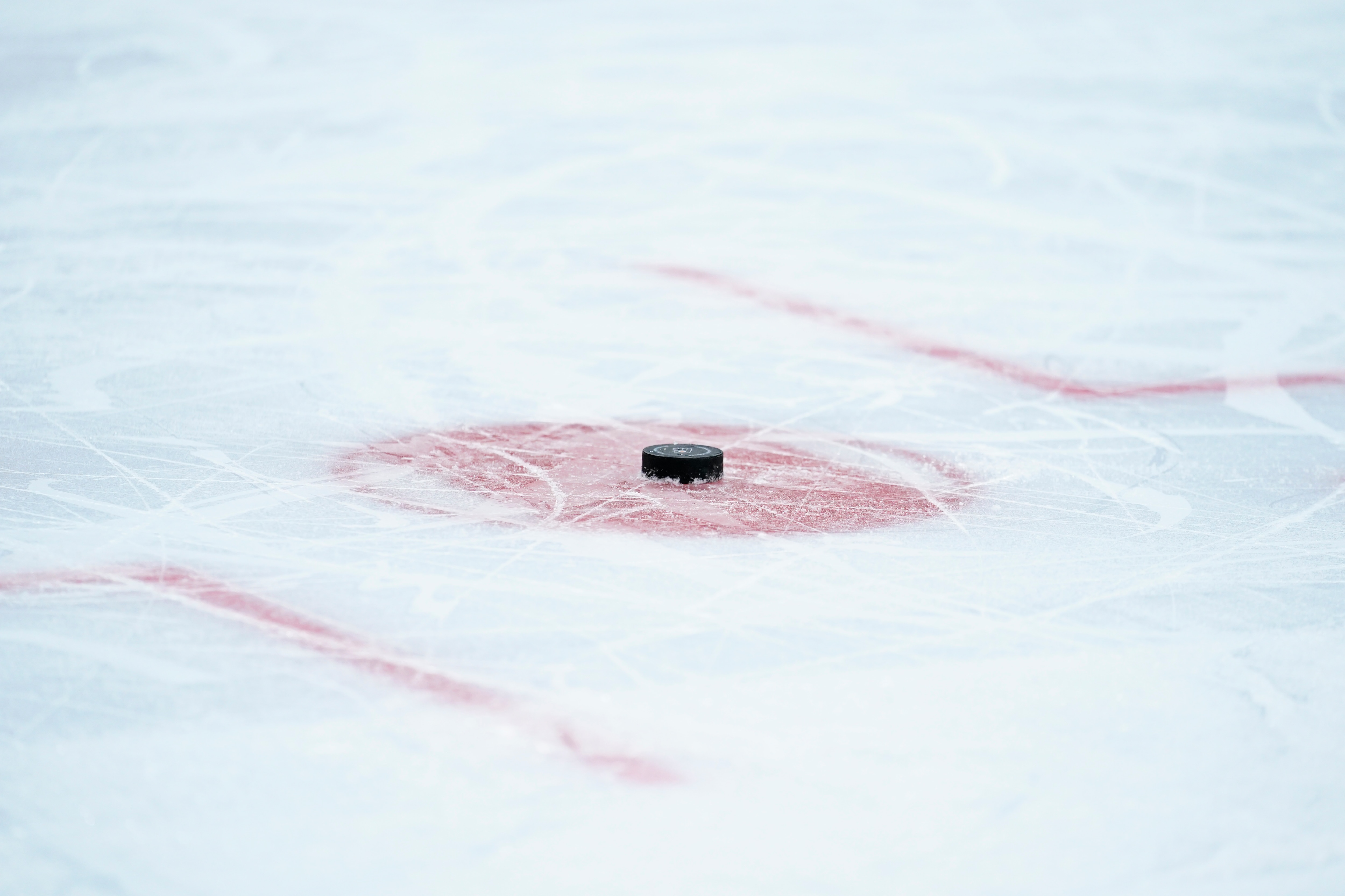A hockey puck is seen during a preseason NHL hockey game between the Philadelphia Flyers and the New York Islanders , Tuesday, Sept. 28, 2021, in Philadelphia. (AP Photo/Matt Slocum)