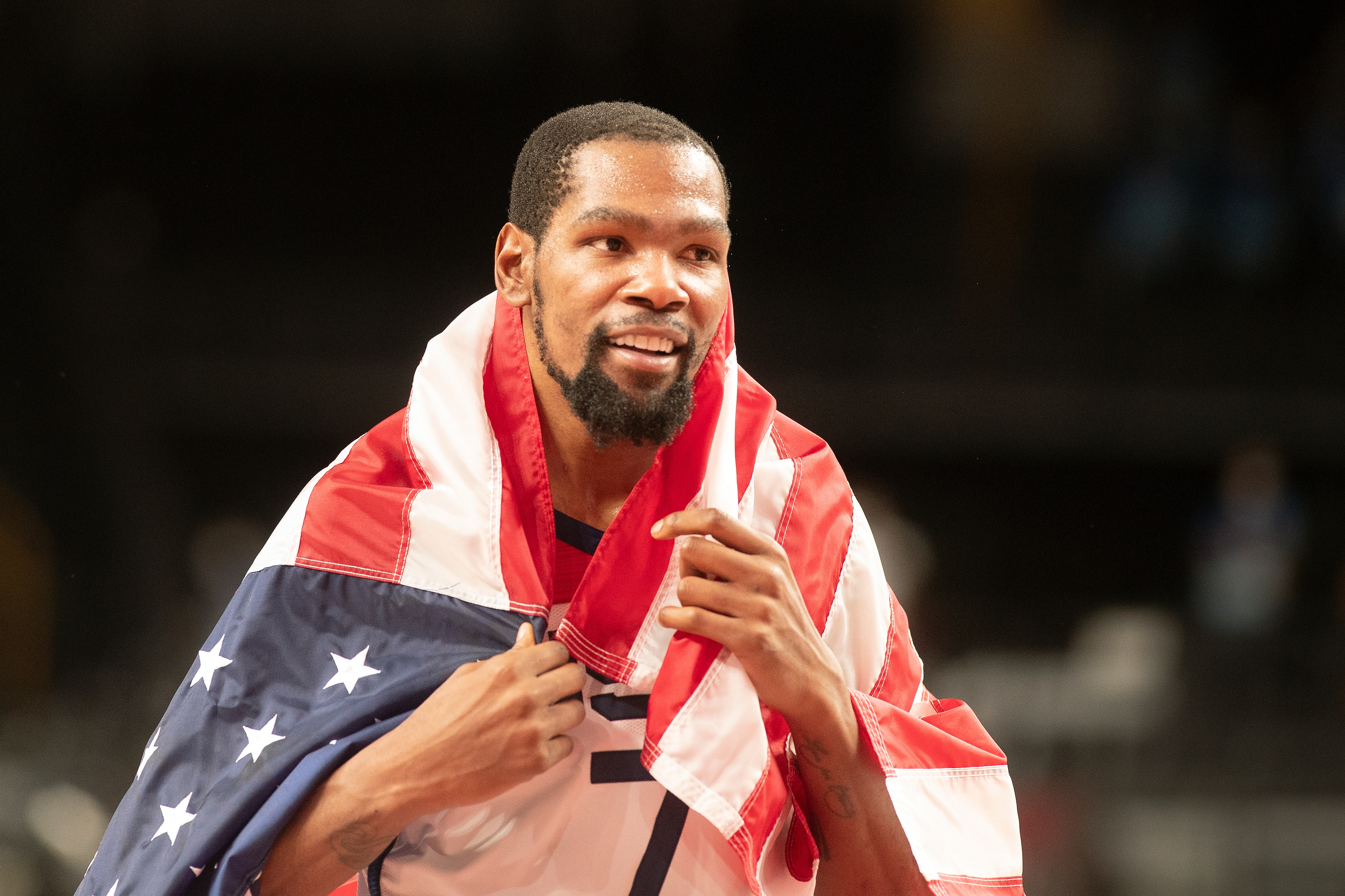 TOKYO, JAPAN August 7:  Kevin Durant #7 of the United States celebrates the teams gold medal victory with the United States flag after the France V USA basket final for men at the Saitama Super Arena during the Tokyo 2020 Summer Olympic Games on August 7, 2021 in Tokyo, Japan. (Photo by Tim Clayton/Corbis via Getty Images)
