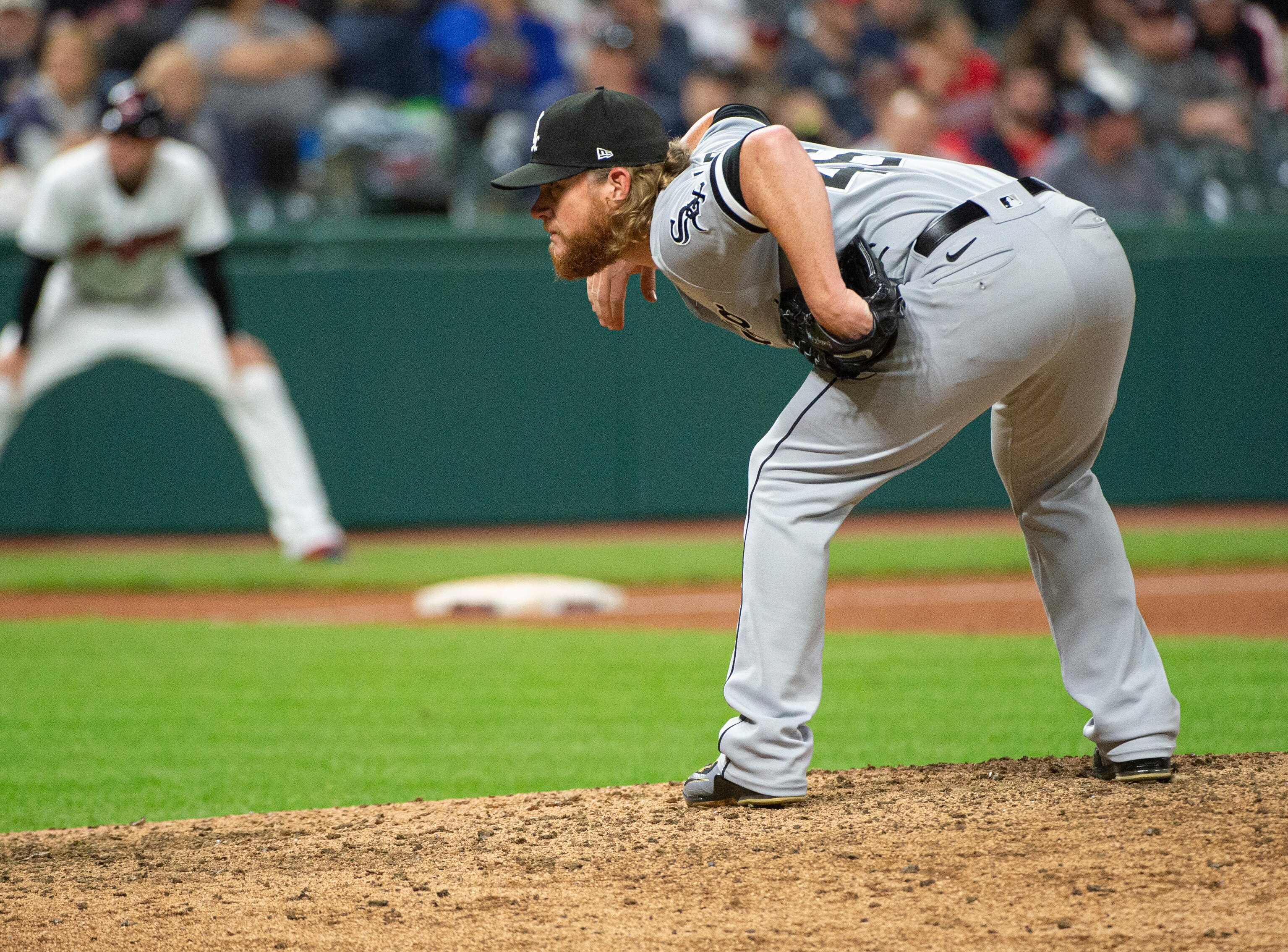 Chicago White Sox relief pitcher Craig Kimbrel looks for a sign during a baseball game against the Cleveland Indians in Cleveland, Friday, Sept. 24, 2021. (AP Photo/Phil Long)
