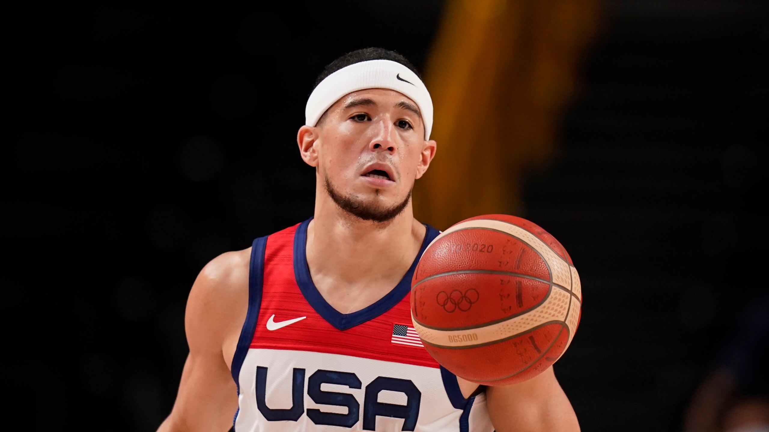 United States' Devin Booker (15) drives to the basket during men's basketball preliminary round game against Iran at the 2020 Summer Olympics, Wednesday, July 28, 2021, in Saitama, Japan. (AP Photo/Charlie Neibergall)