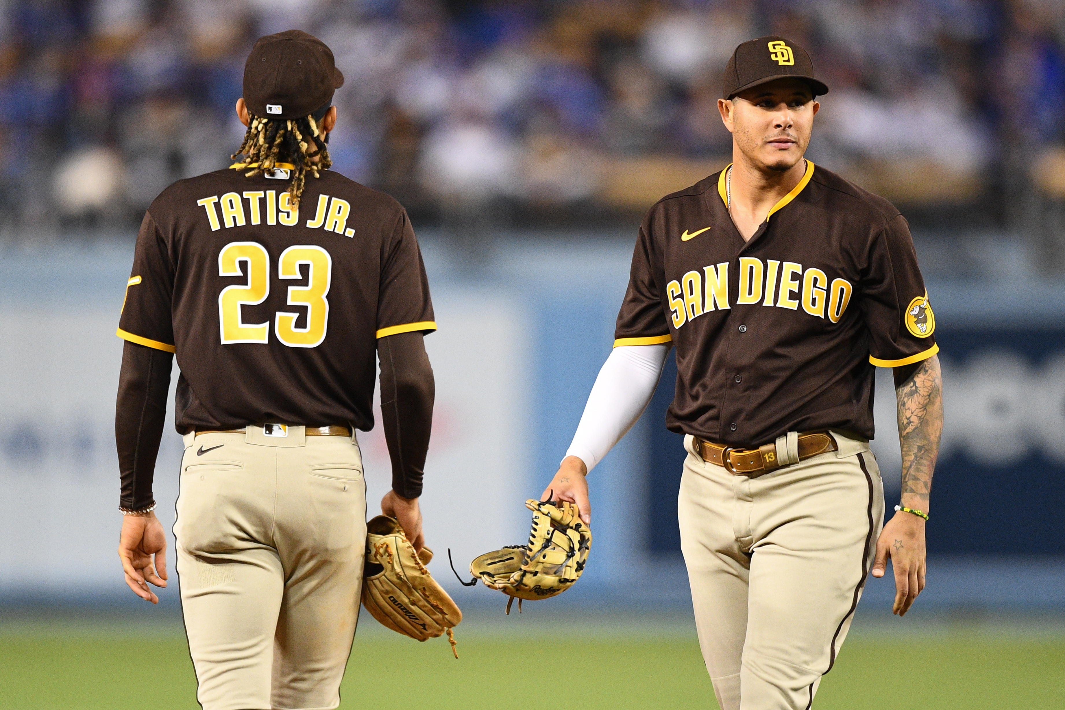 LOS ANGELES, CA - SEPTEMBER 28: San Diego Padres shortstop Fernando Tatis Jr. (23) and San Diego Padres third baseman Manny Machado (13) walk by each other  during the MLB game between the San Diego Padres and the Los Angeles Dodgers on September 28, 2021 at Dodger Stadium in Los Angeles, CA. (Photo by Brian Rothmuller/Icon Sportswire via Getty Images)