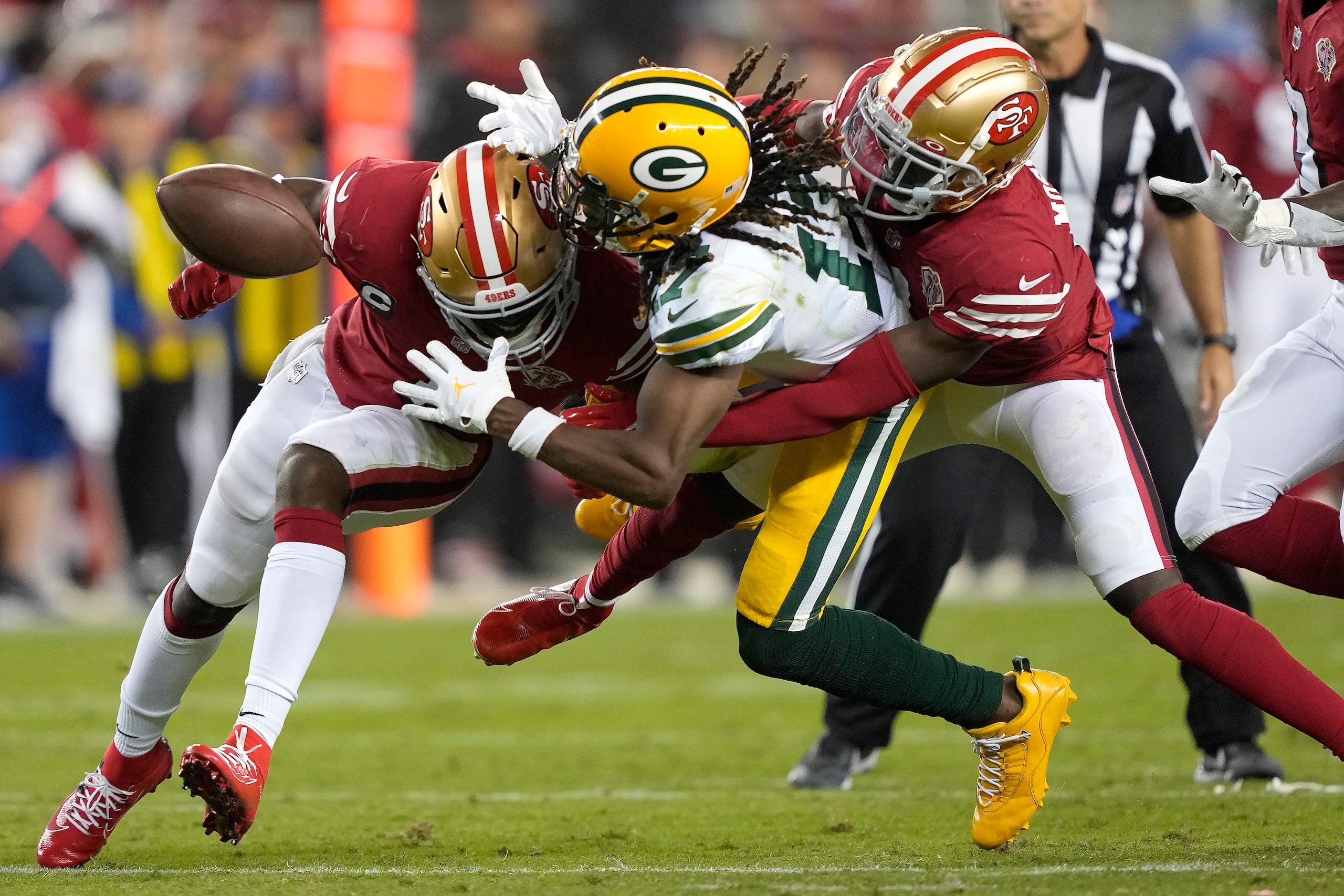 Green Bay Packers wide receiver Davante Adams, middle, cannot catch a pass between San Francisco 49ers cornerback Jimmie Ward, left, and defensive back Emmanuel Moseley during the second half of an NFL football game in Santa Clara, Calif., Sunday, Sept. 26, 2021. (AP Photo/Tony Avelar) Green Bay Packers wide receiver Davante Adams, middle, cannot catch a pass between San Francisco 49ers cornerback Jimmie Ward, left, and defensive back Emmanuel Moseley during the second half of an NFL football game in Santa Clara, Calif., Sunday, Sept. 26, 2021. (AP Photo/Tony Avelar)