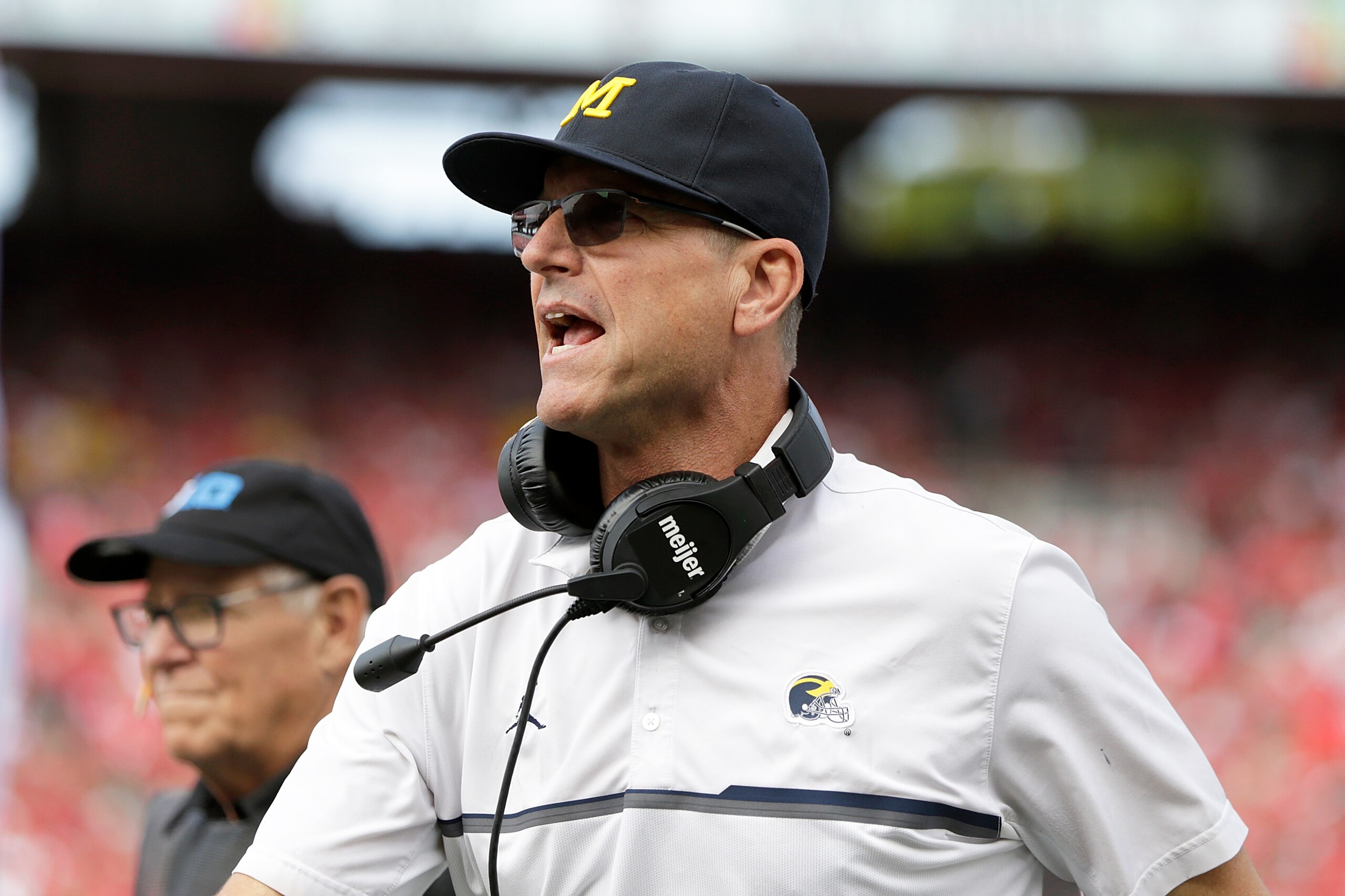 MADISON, WISCONSIN - OCTOBER 02: Michigan head coach Jim Harbaugh runs down the sidelines after a 34 yard touchdown pass in the first quarter Wisconsin Badgers at Camp Randall Stadium on October 02, 2021 in Madison, Wisconsin. (Photo by John Fisher/Getty Images)