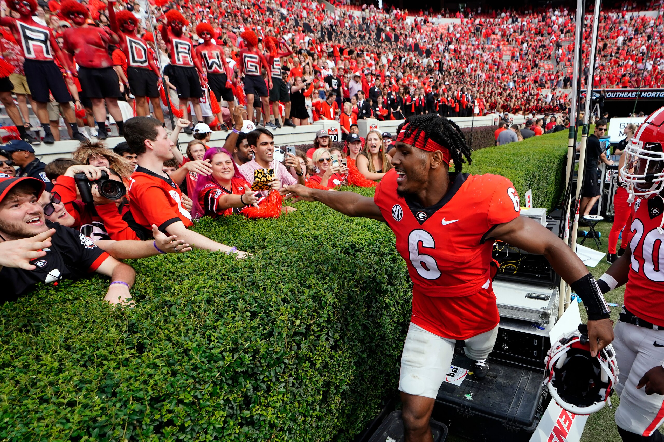 Georgia running back Kenny McIntosh (6) celebrates with the fans after defeating Arkansas in an NCAA college football game Saturday, Oct. 2, 2021, in Athens, Ga.. (AP Photo/John Bazemore)