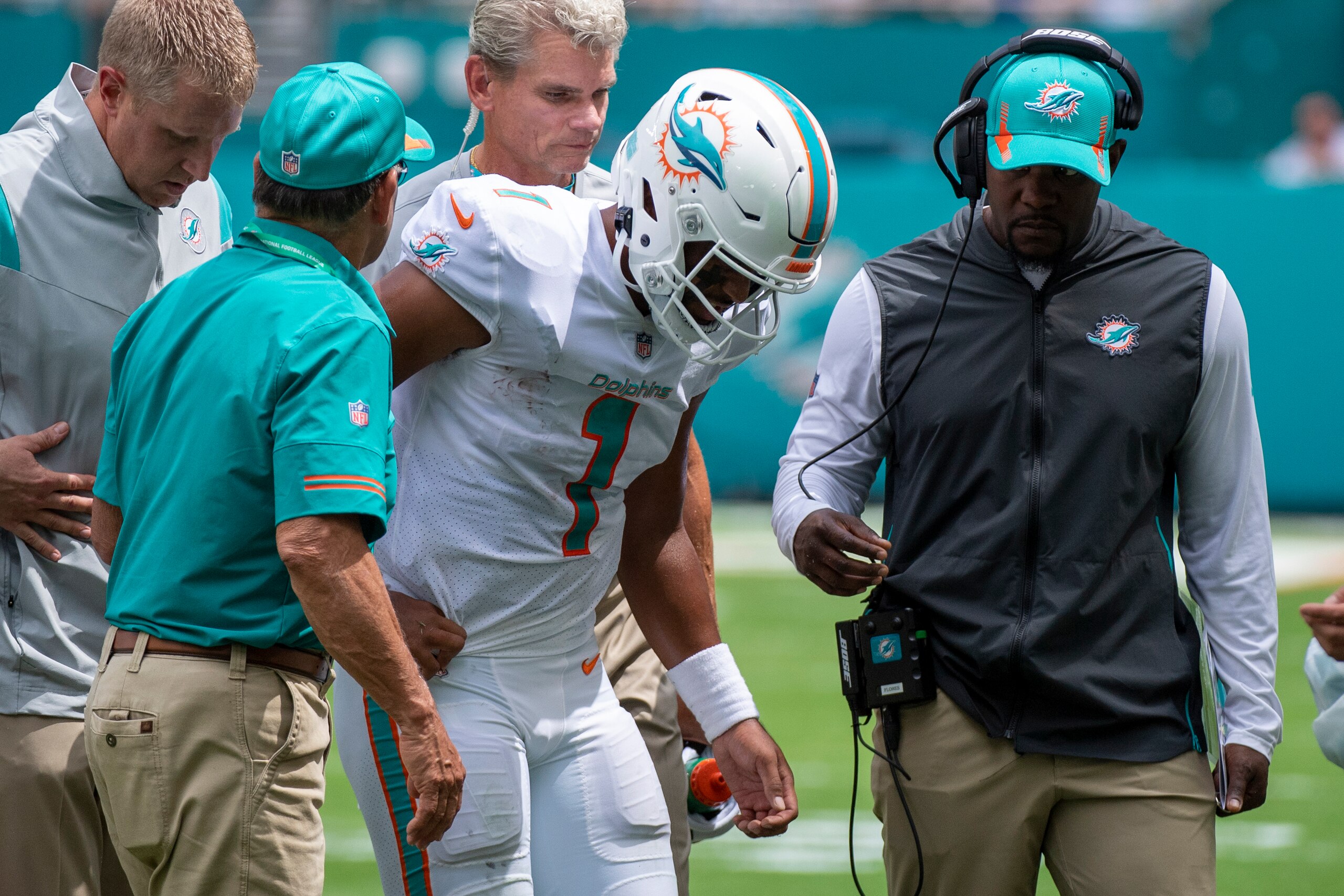 Miami Dolphins quarterback Tua Tagovailoa (1) is helped off of the field with a rib injury along with Miami Dolphins head coach Brian Flores (right) during an NFL football game against the Buffalo Bills, Sunday, Sept. 19, 2021, in Miami Gardens, Fla. (AP Photo/Doug Murray)